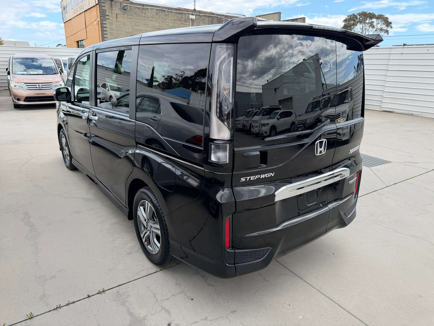 2018 Honda Honda Stepwgn 2.0 Spada Hybrid in black, rear view, showcasing modern design and spacious MPV features.