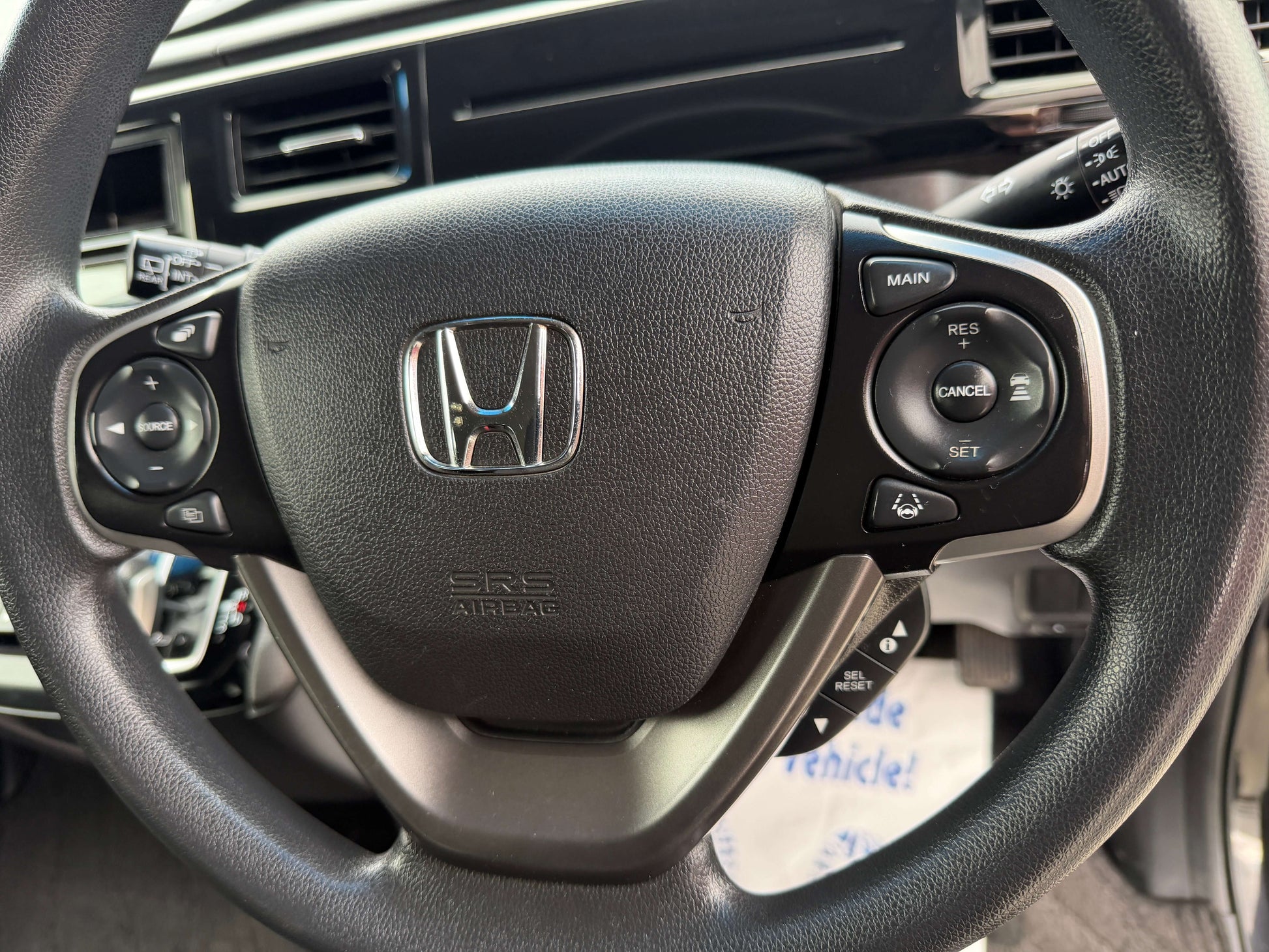 Interior view of the steering wheel of a 2018 Honda Honda Stepwgn 2.0 Spada Hybrid showing control buttons.