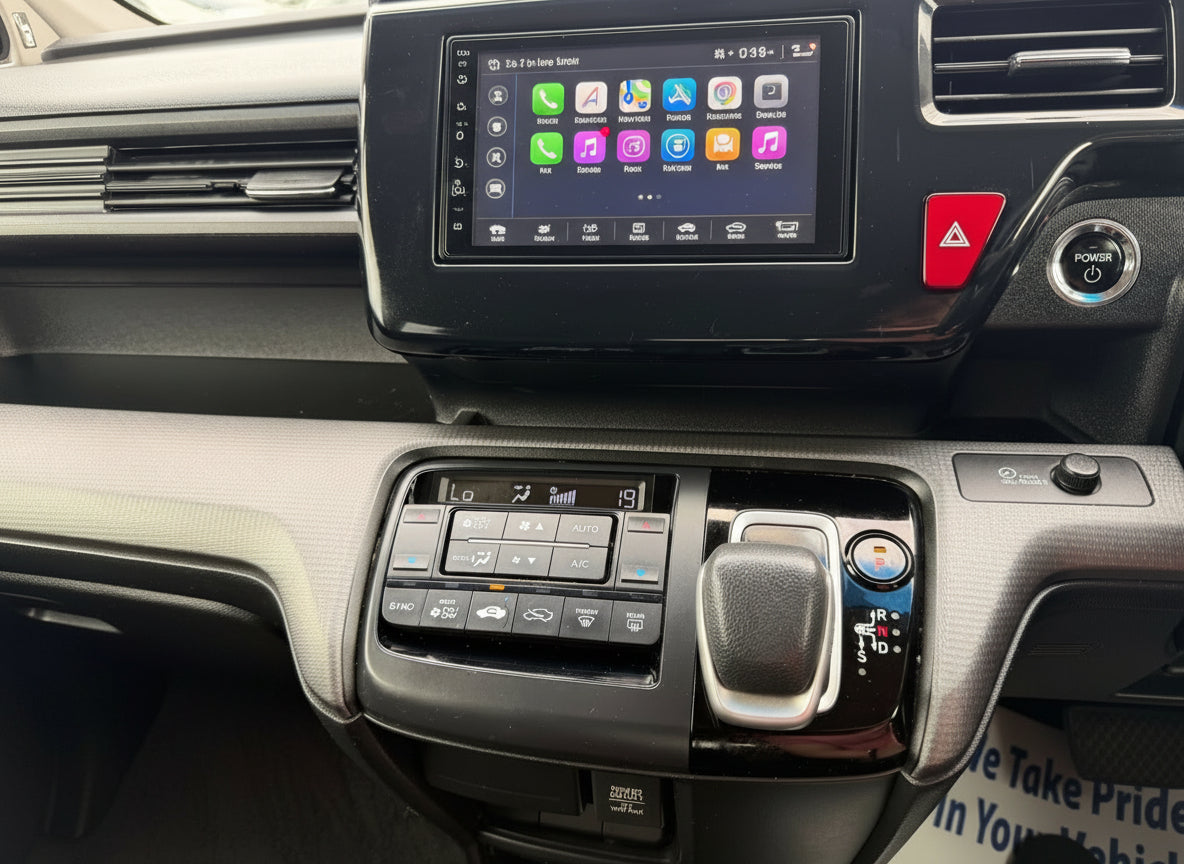 Interior dashboard controls of a 2018 Honda Honda Stepwgn 2.0 Spada Hybrid, featuring audio and climate controls.