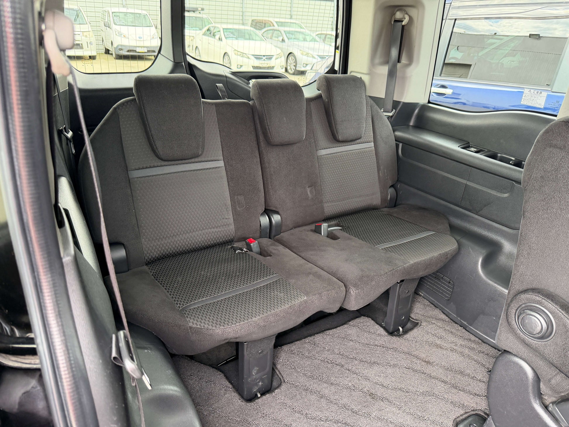 Interior view of the spacious rear seating in a 2018 Honda Honda Stepwgn 2.0 Spada Hybrid G, suitable for 7 passengers.