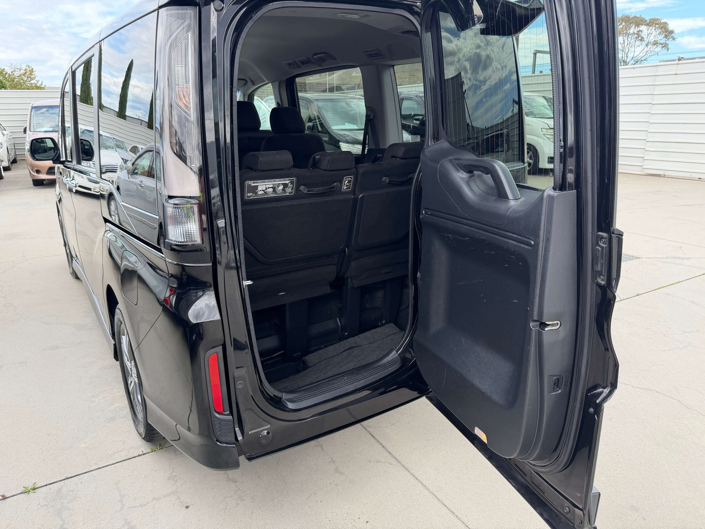 Interior view of the 2018 Honda Honda Stepwgn 2.0 Spada Hybrid showing rear seating and door.