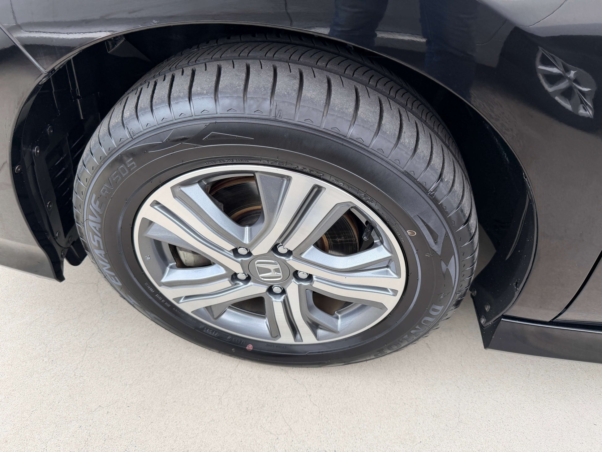 Close-up of a wheel and tire of a 2018 Honda Honda Stepwgn 2.0 Spada Hybrid, showcasing alloy rims and tread design.