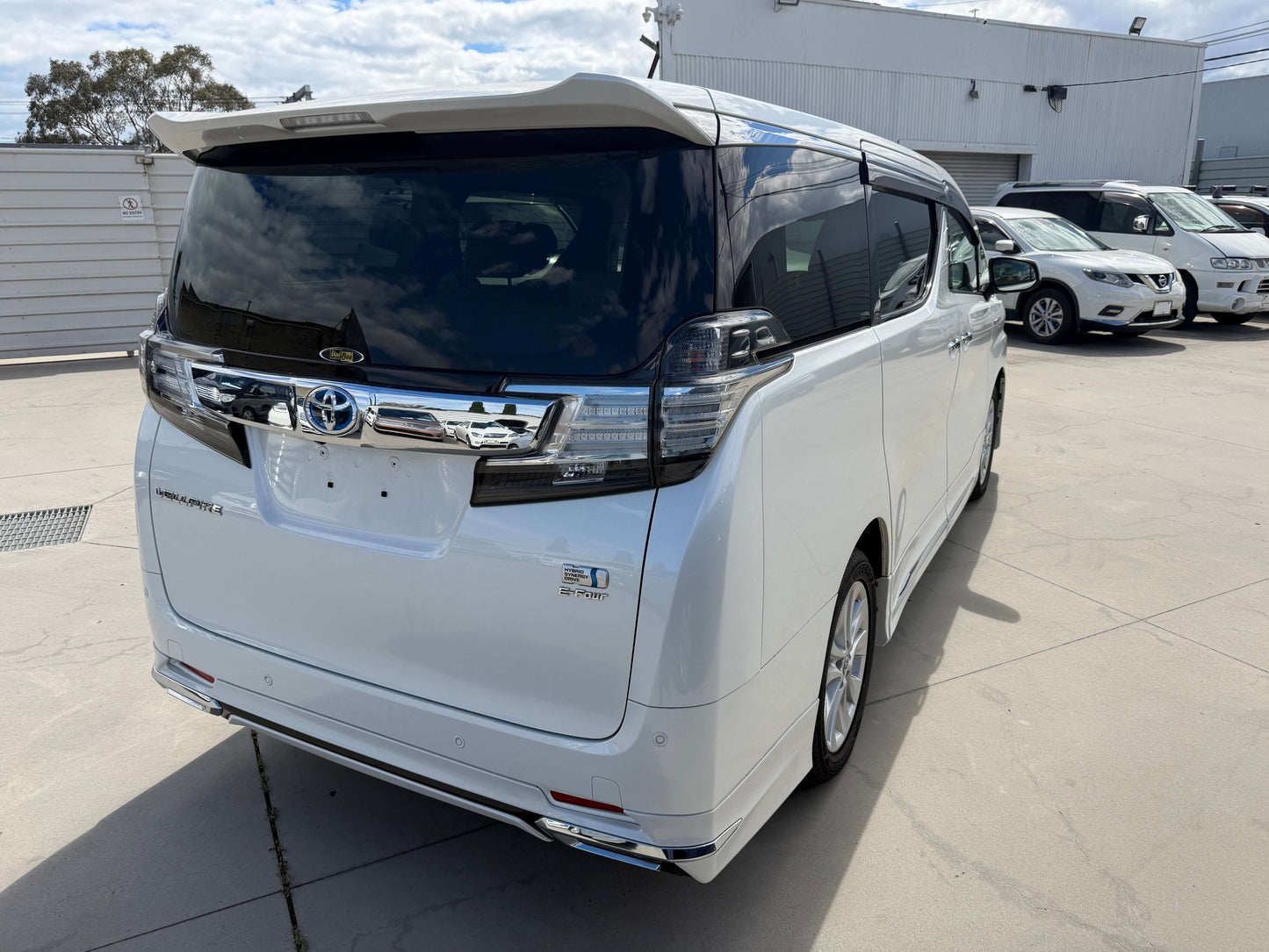 2015 Toyota Vellfire 2.5L e-Four Hybrid V-L Edition white luxury people mover rear view.