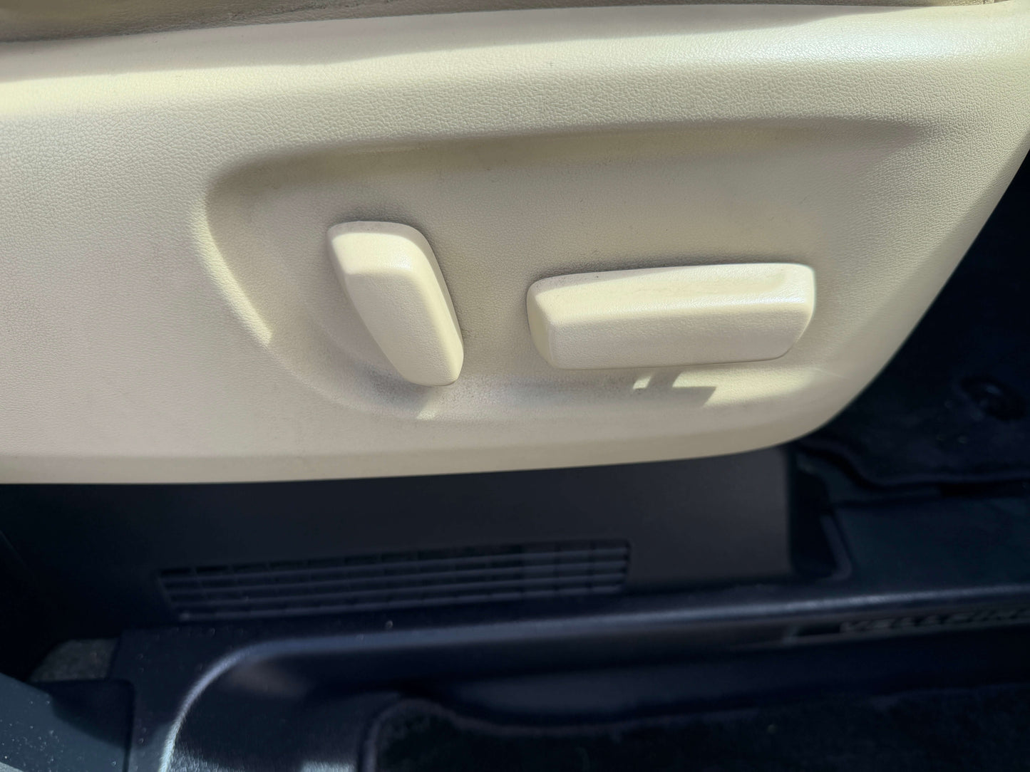 Close-up of the seat adjustment controls in a 2015 Toyota Vellfire 2.5L e-Four Hybrid interior.