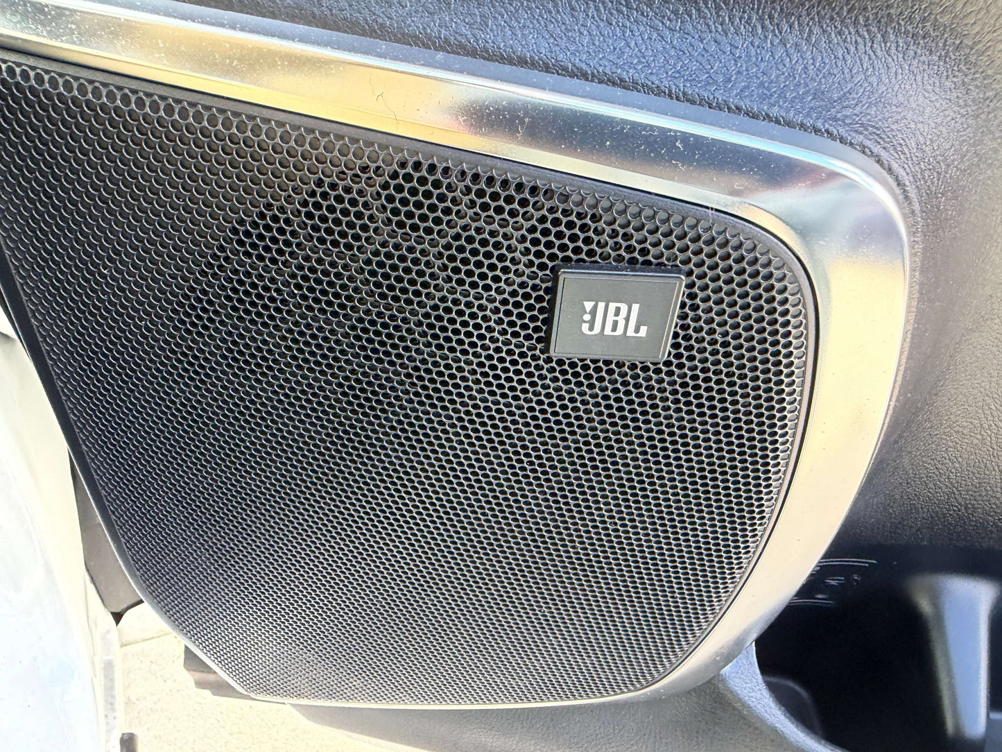 2015 Toyota Vellfire 2.5L e-Four Hybrid Close-up of a JBL speaker located in the interior of a vehicle, showcasing its sleek design and mesh grille.