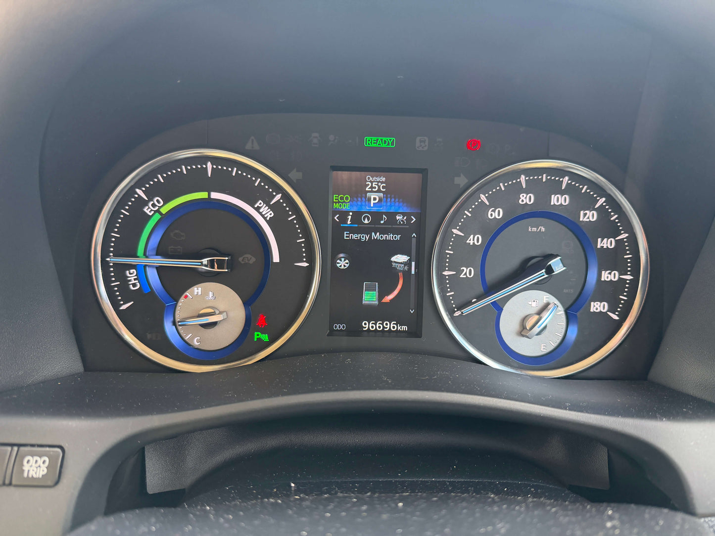 Dashboard of a 2015 Toyota Vellfire 2.5L e-Four Hybrid displaying fuel efficiency and energy monitor.