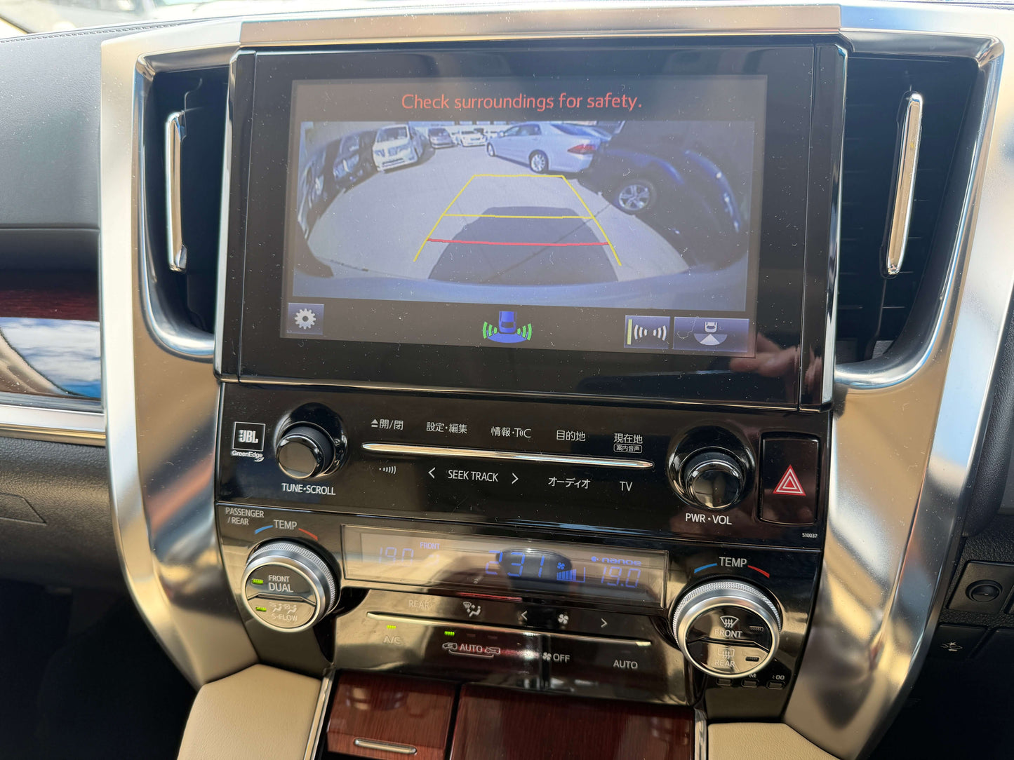 2015 Toyota Vellfire 2.5L e-Four Hybrid dashboard with rearview camera display showing safety guidelines.