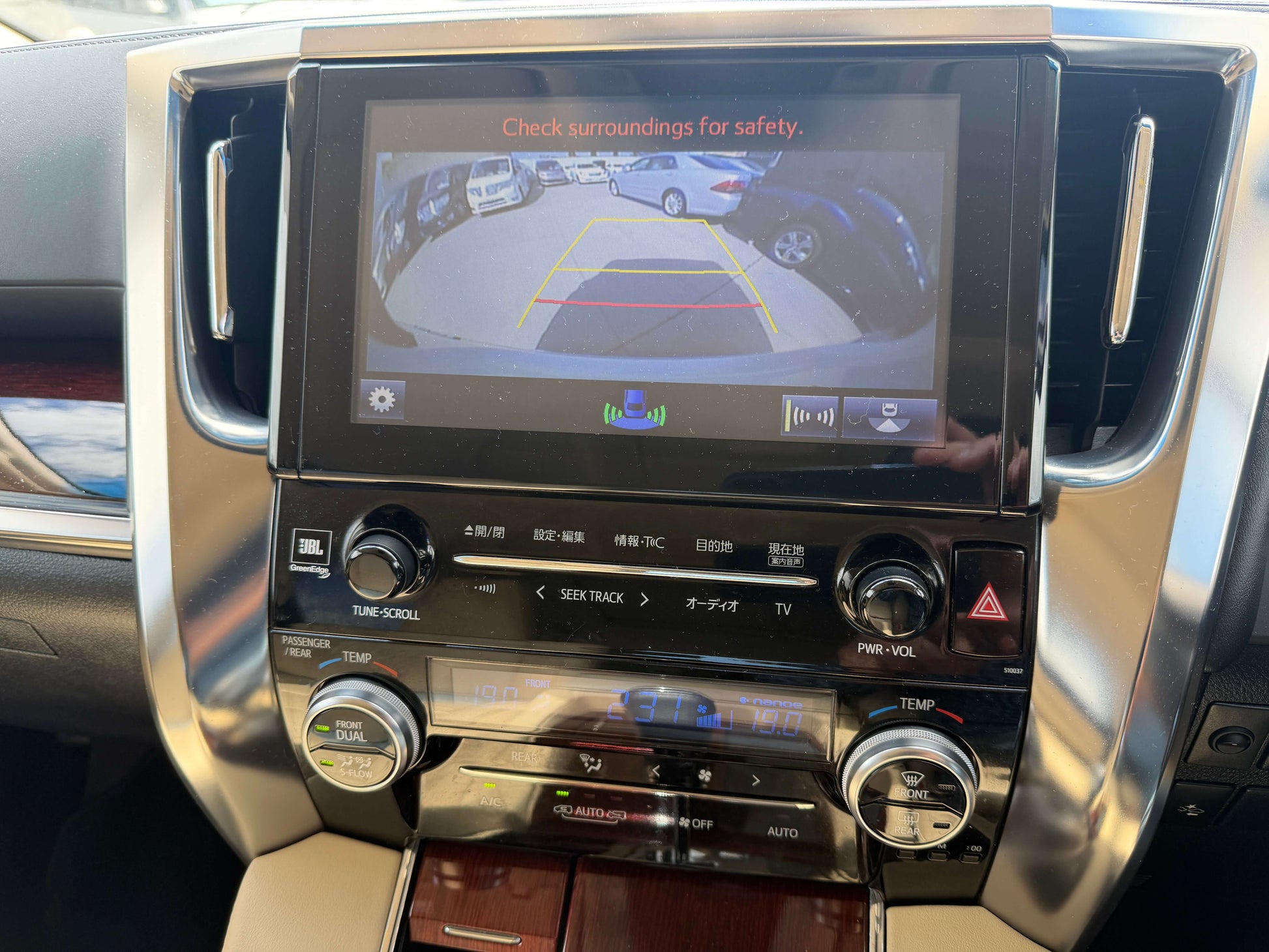 2015 Toyota Vellfire 2.5L e-Four Hybrid dashboard with rearview camera display showing safety guidelines.