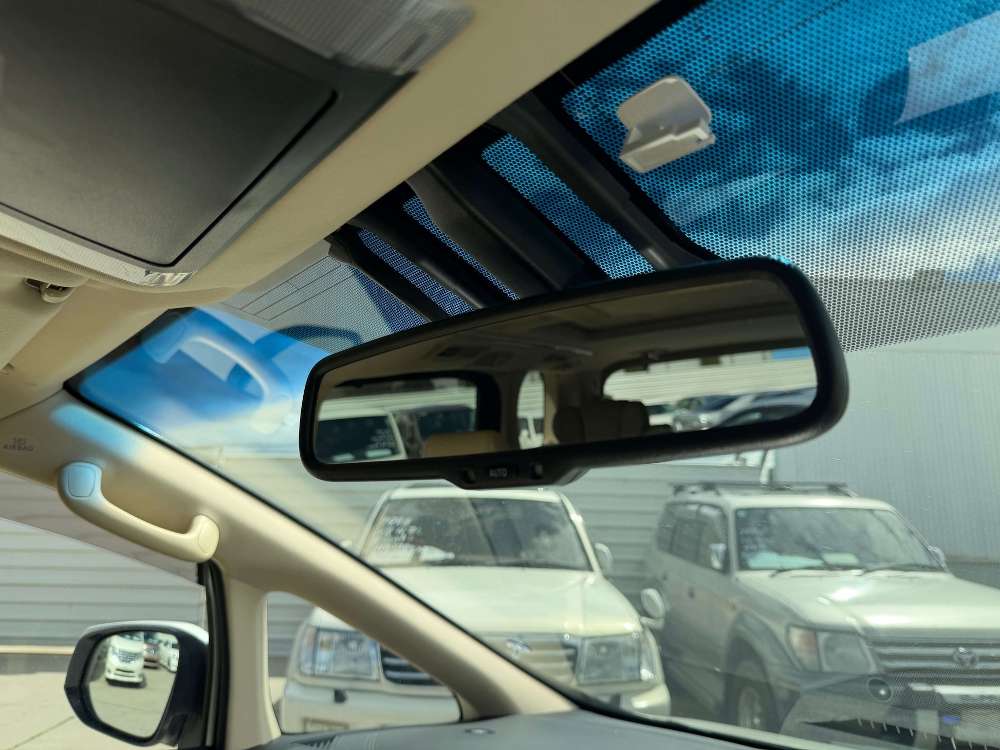 Interior view of rearview mirror in a 2015 Toyota Vellfire 2.5L e-Four Hybrid, showcasing spacious seating and design.