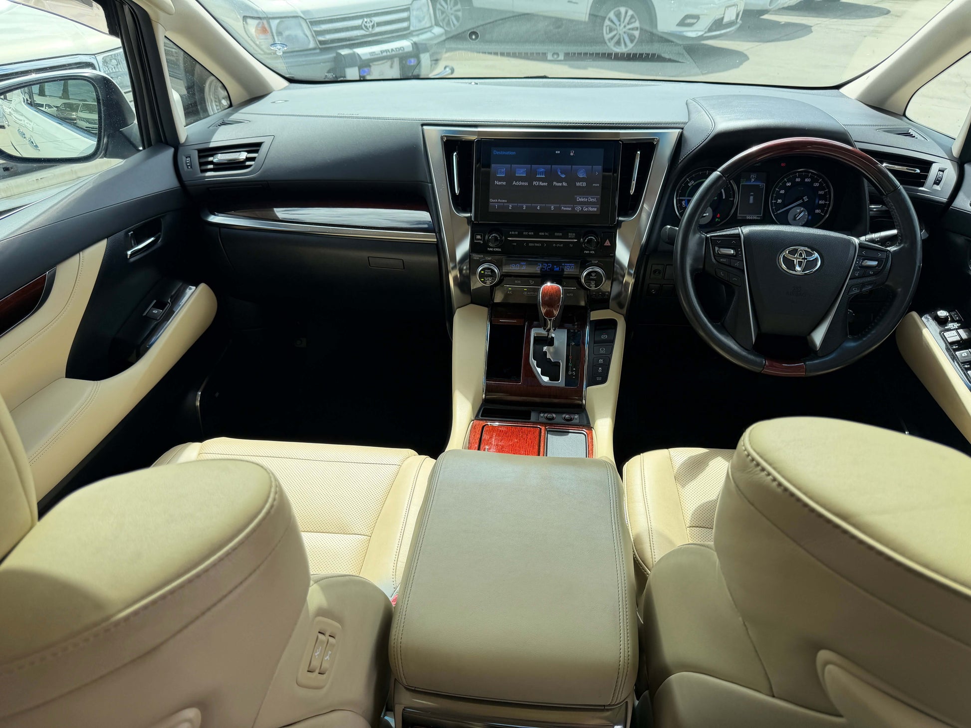Interior view of 2015 Toyota Vellfire 2.5L e-Four Hybrid featuring a luxurious cabin and advanced dashboard.