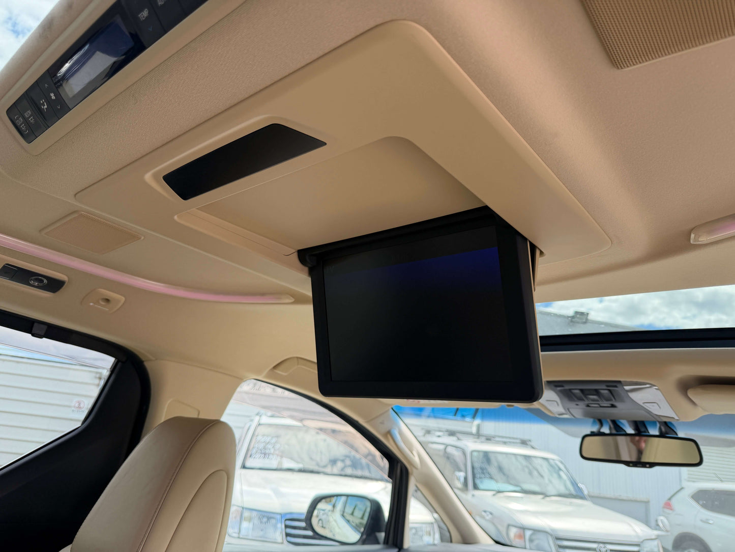 Interior view of a 2015 Toyota Vellfire 2.5L e-Four Hybrid showing overhead monitor for passengers.