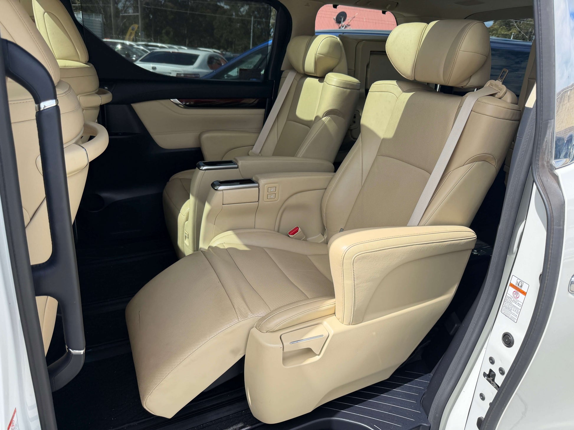 Interior seating of 2015 Toyota Vellfire 2.5L e-Four Hybrid, showcasing luxurious leather seats.
