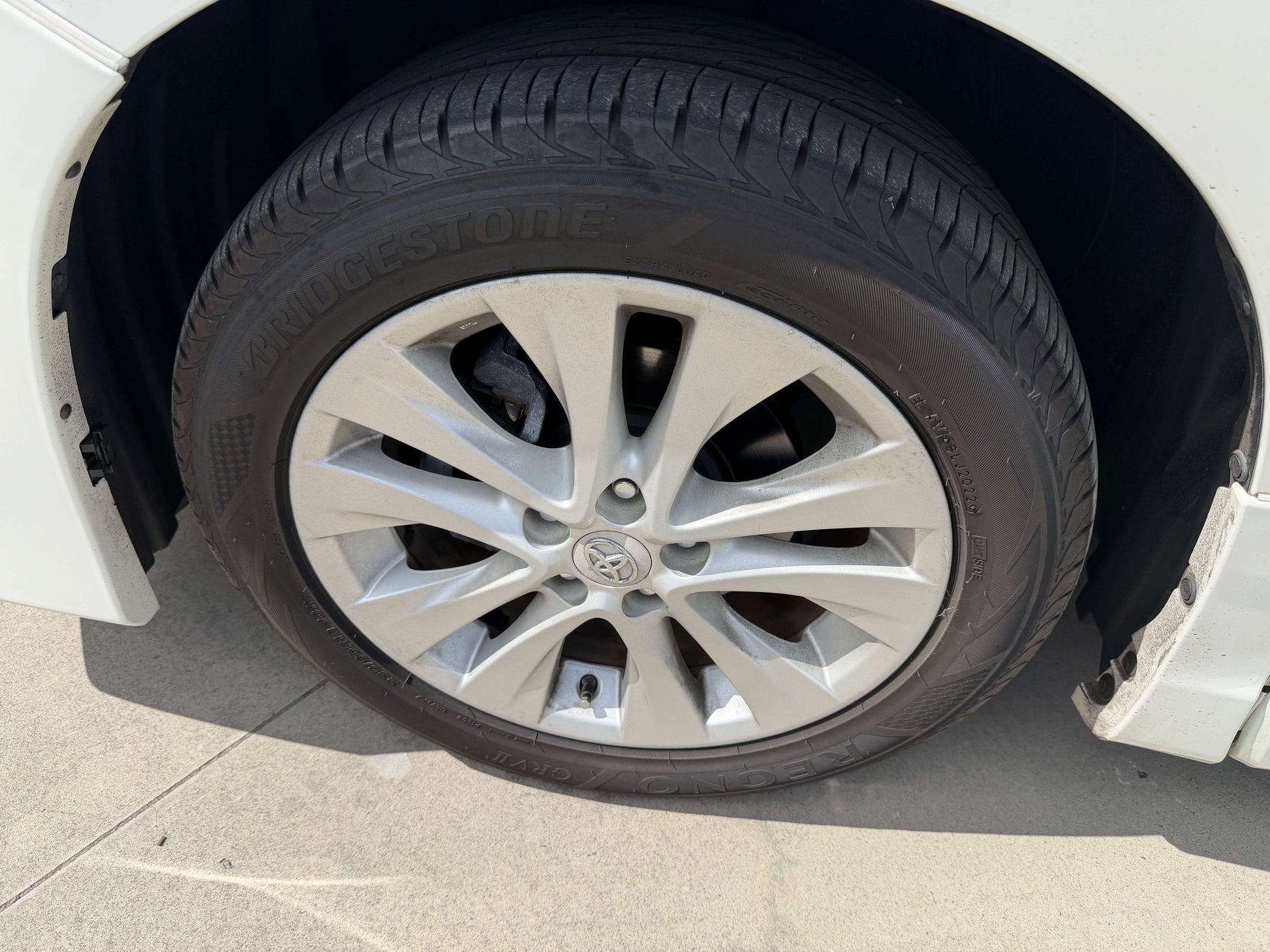 Close-up of a wheel and tire of a 2015 Toyota Vellfire 2.5L e-Four Hybrid showcasing the Bridgestone tire.