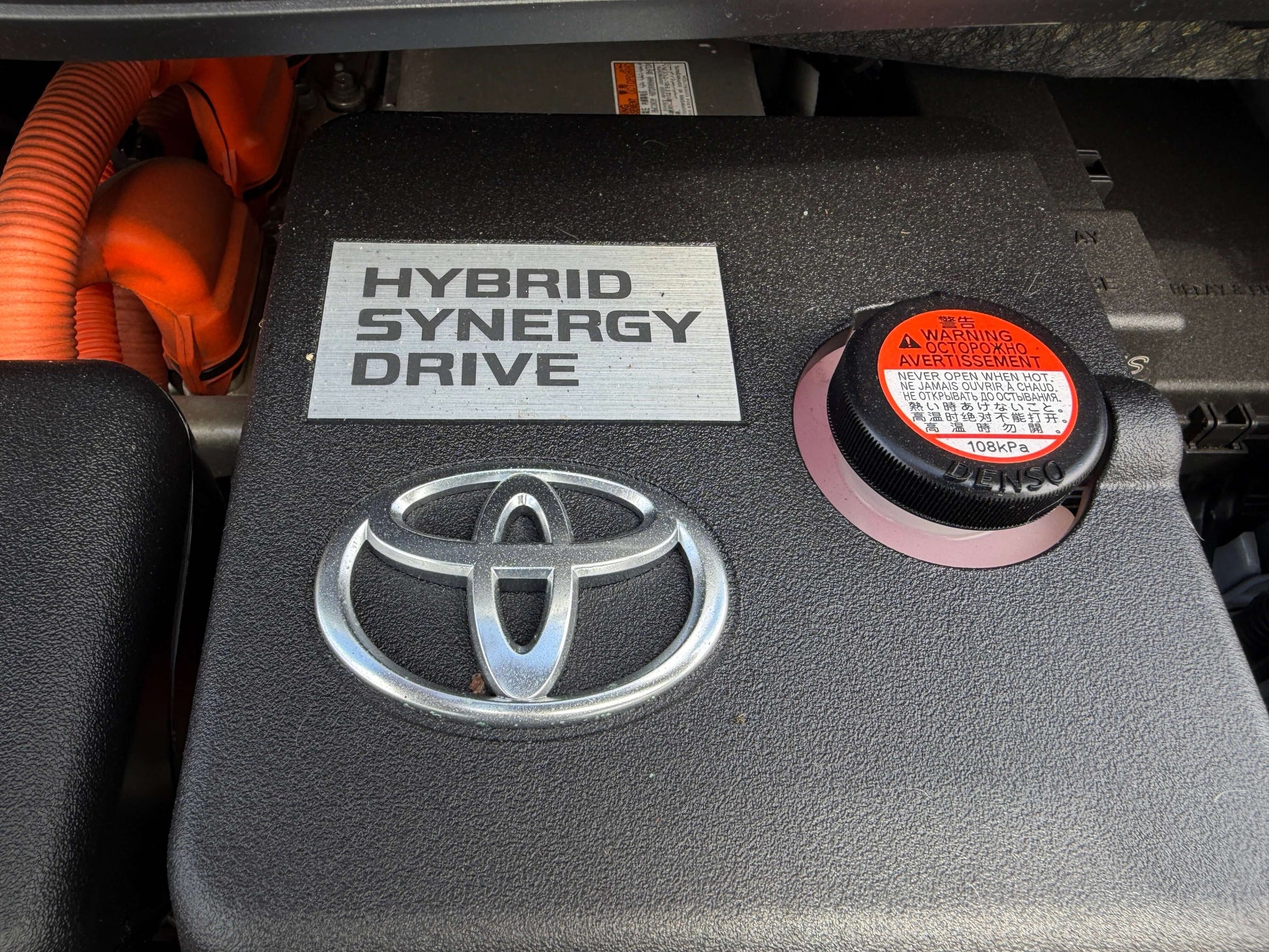 Hybrid Synergy Drive label on the engine of a 2015 Toyota Vellfire 2.5L e-Four Hybrid vehicle.