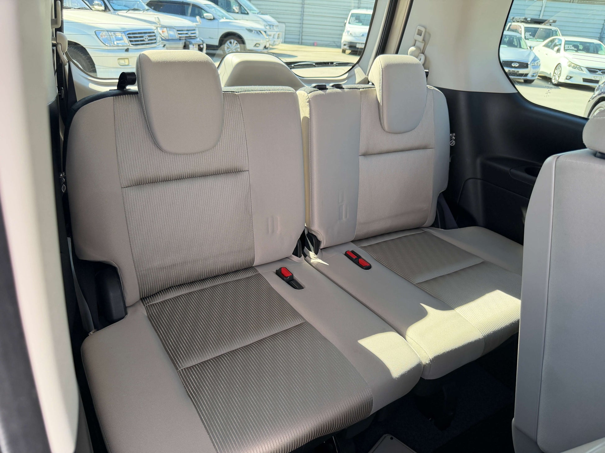 Interior view of the rear seating area of a 2017 Nissan Serena 2.0L S-Hybrid with spacious and comfortable seats.