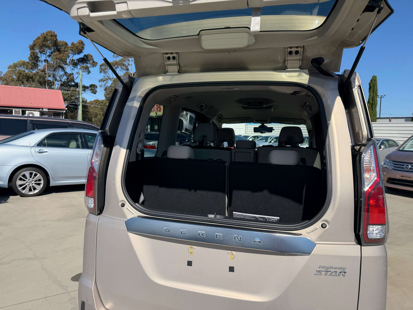 2017 Nissan Serena 2.0L S-Hybrid interior view showing spacious trunk area with seats folded down.