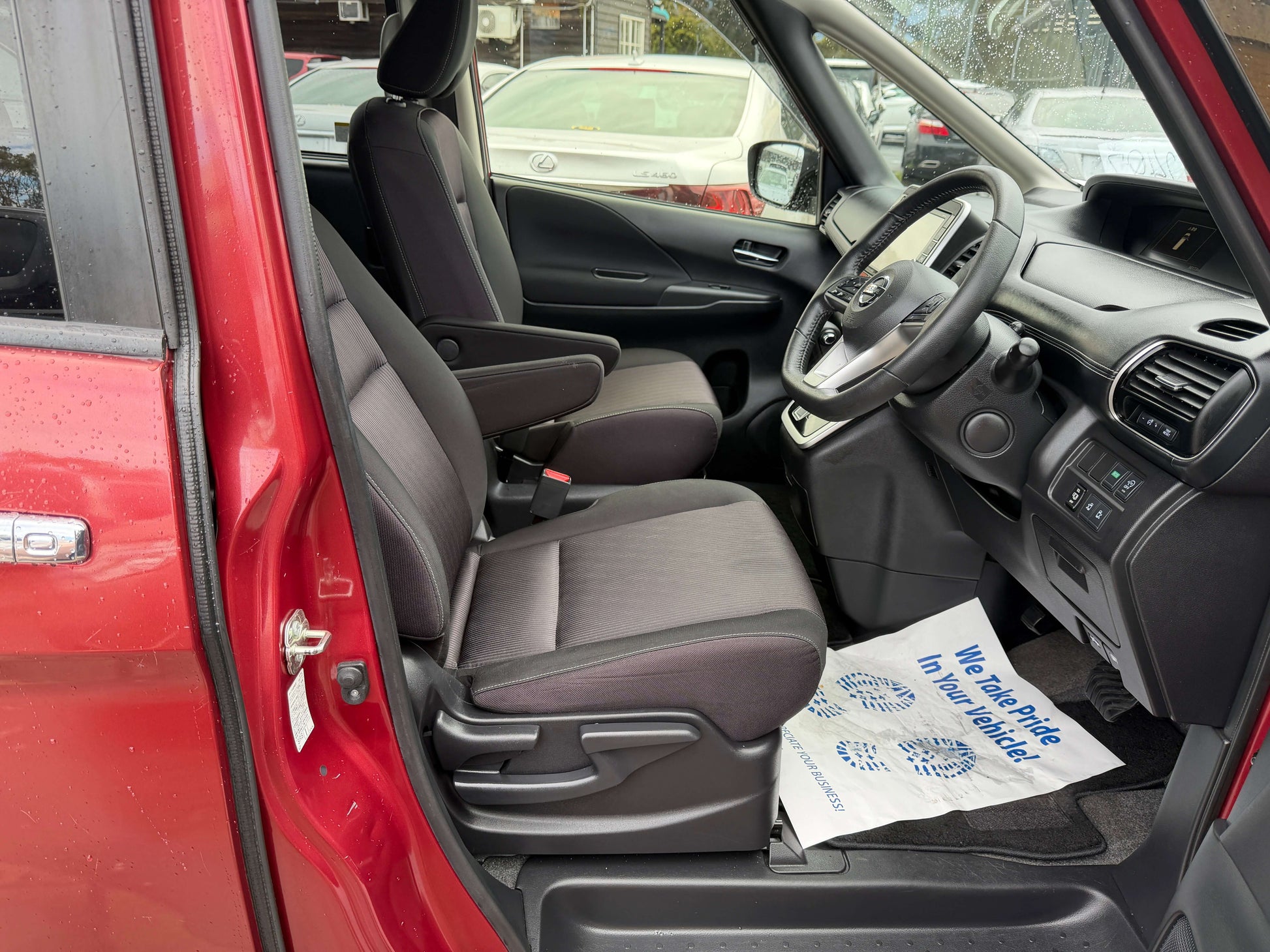 Interior view of the 2018 Nissan Serena 2.0L S-Hybrid Highway Star, showcasing front seats and dashboard.