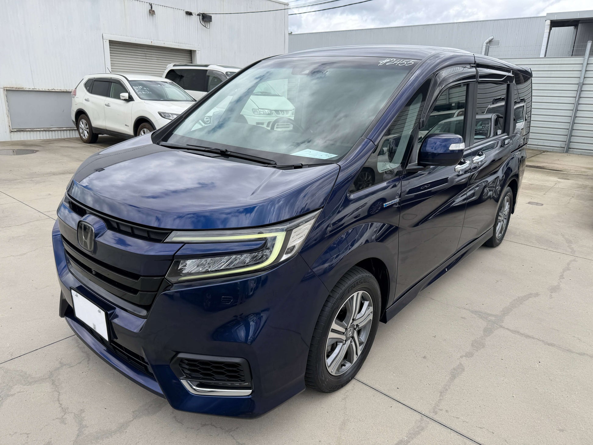 2018 Honda Honda Stepwgn 2.0 Spada Hybrid G EX Honda Sensing blue MPV parked on a lot with modern design and spacious look.