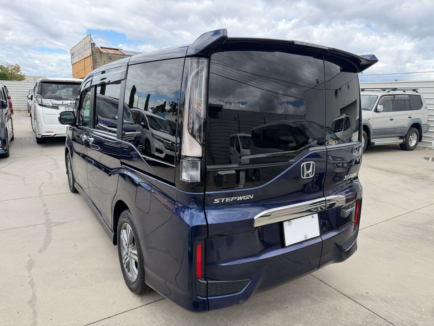 Rear view of a blue 2018 Honda Honda Stepwgn 2.0 Spada Hybrid G EX Honda Sensing parked outdoors.