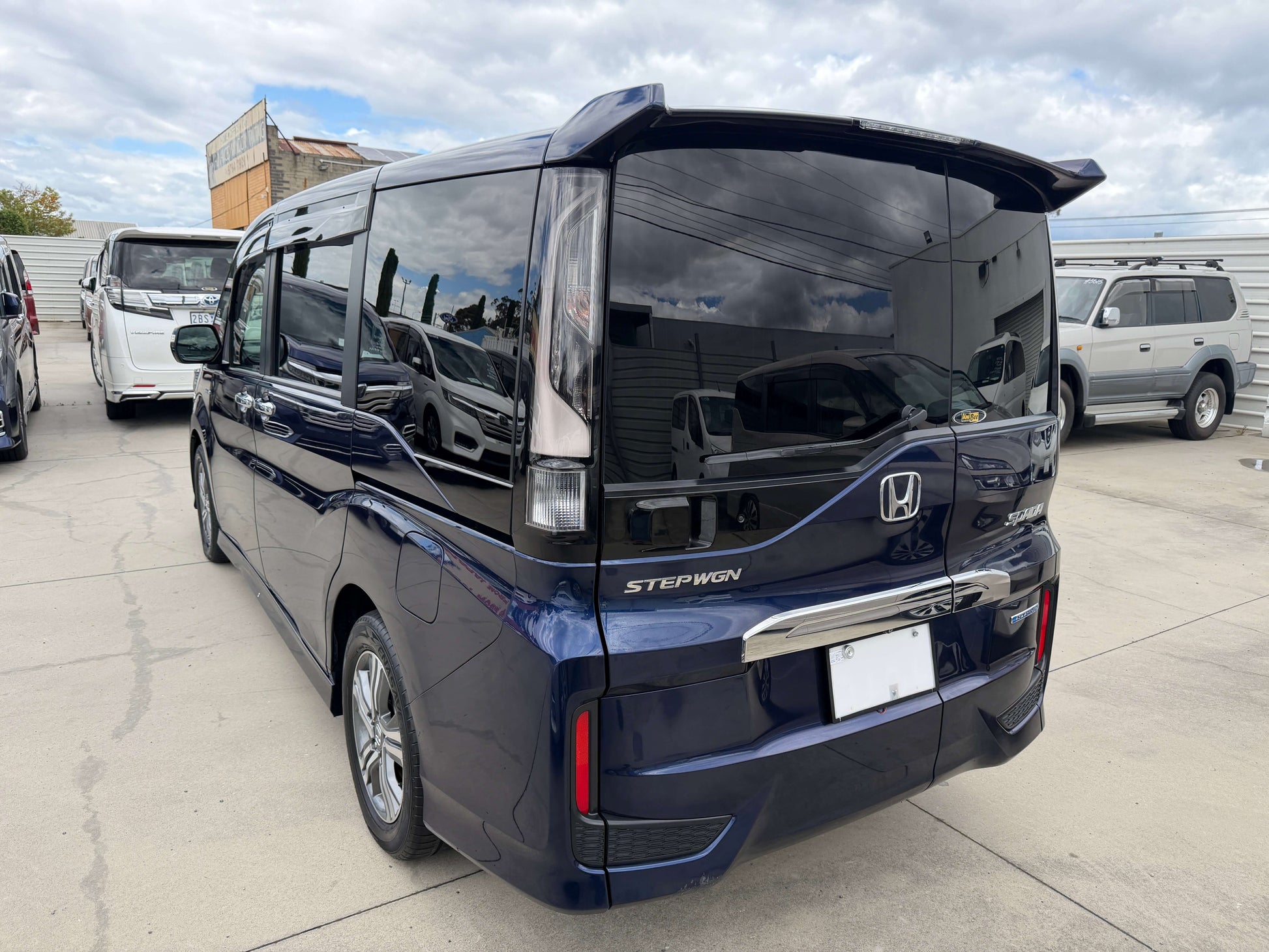 Rear view of a blue 2018 Honda Honda Stepwgn 2.0 Spada Hybrid G EX Honda Sensing parked outdoors.