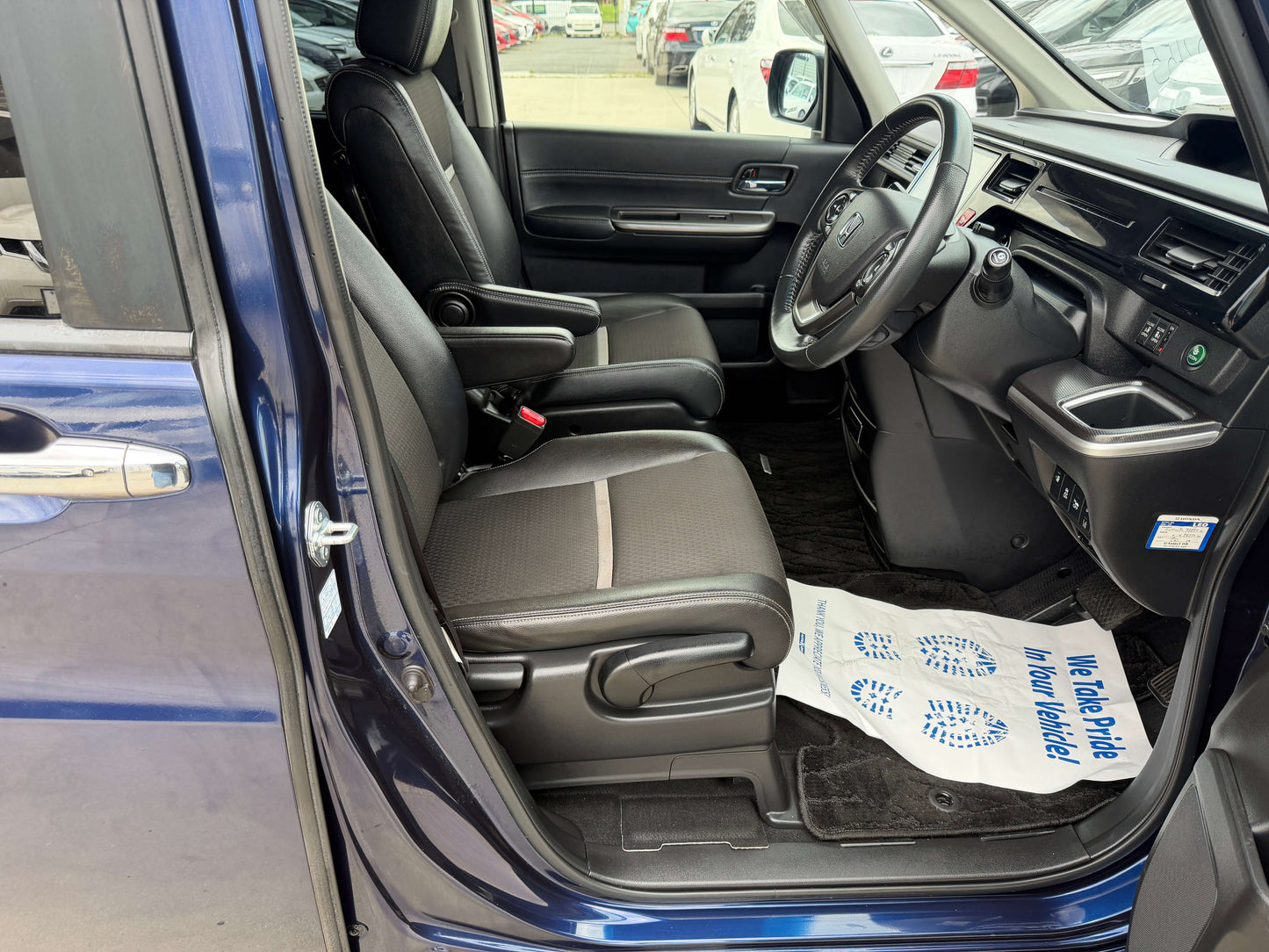 Interior view of a 2018 Honda Honda Stepwgn 2.0 Spada Hybrid with comfortable seating and modern dashboard features.