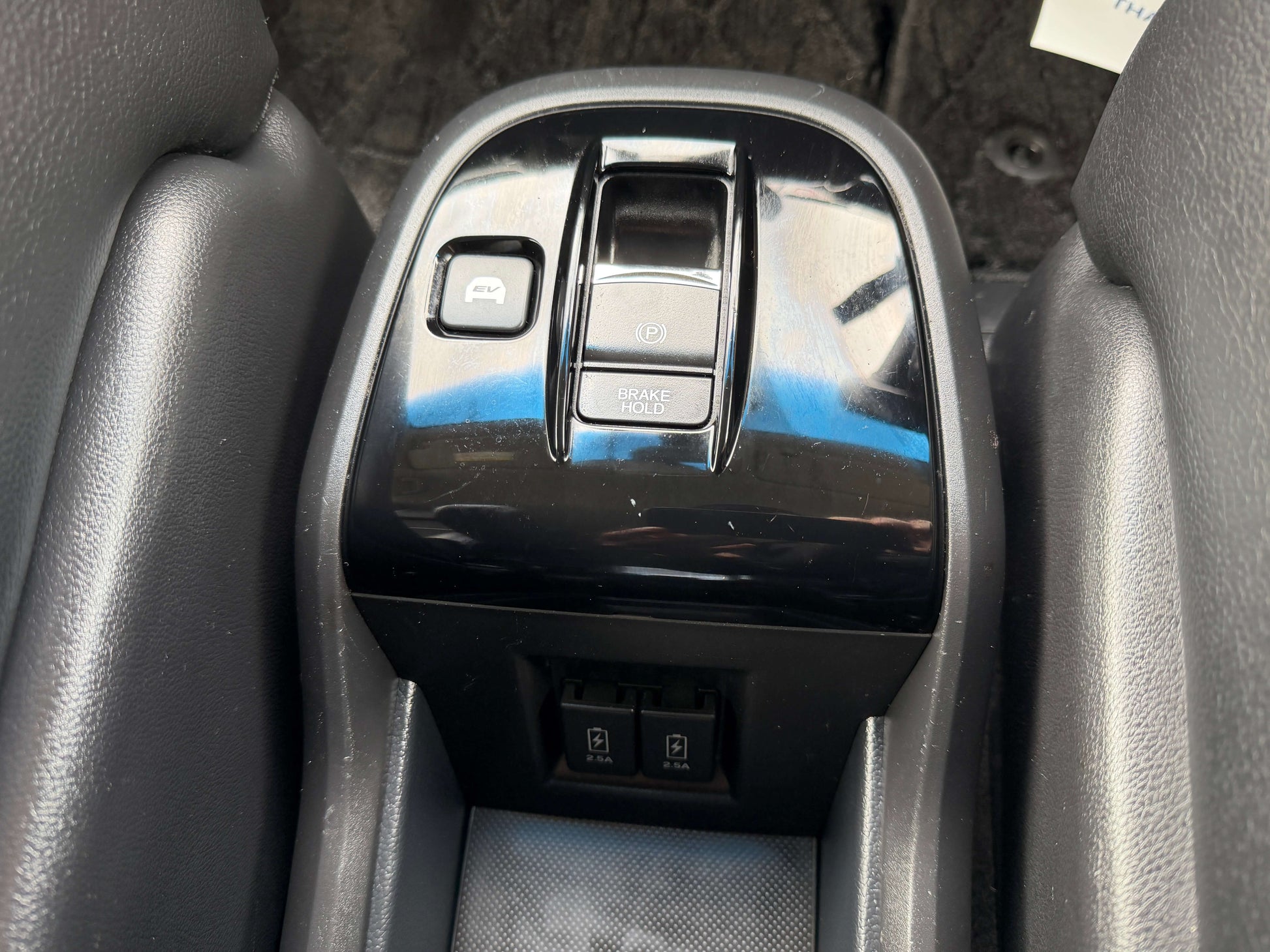 Interior console of a 2018 Honda Honda Stepwgn 2.0 Spada Hybrid with controls for brakes and rear doors.