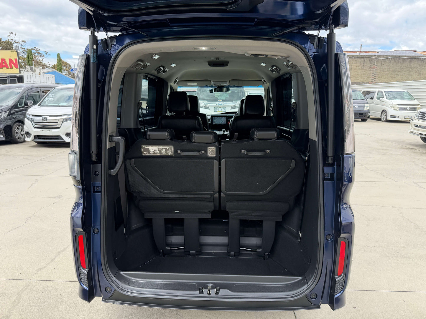 Interior view of the 2018 Honda Honda Stepwgn 2.0 Spada Hybrid G EX Honda Sensing showing rear seating arrangement.