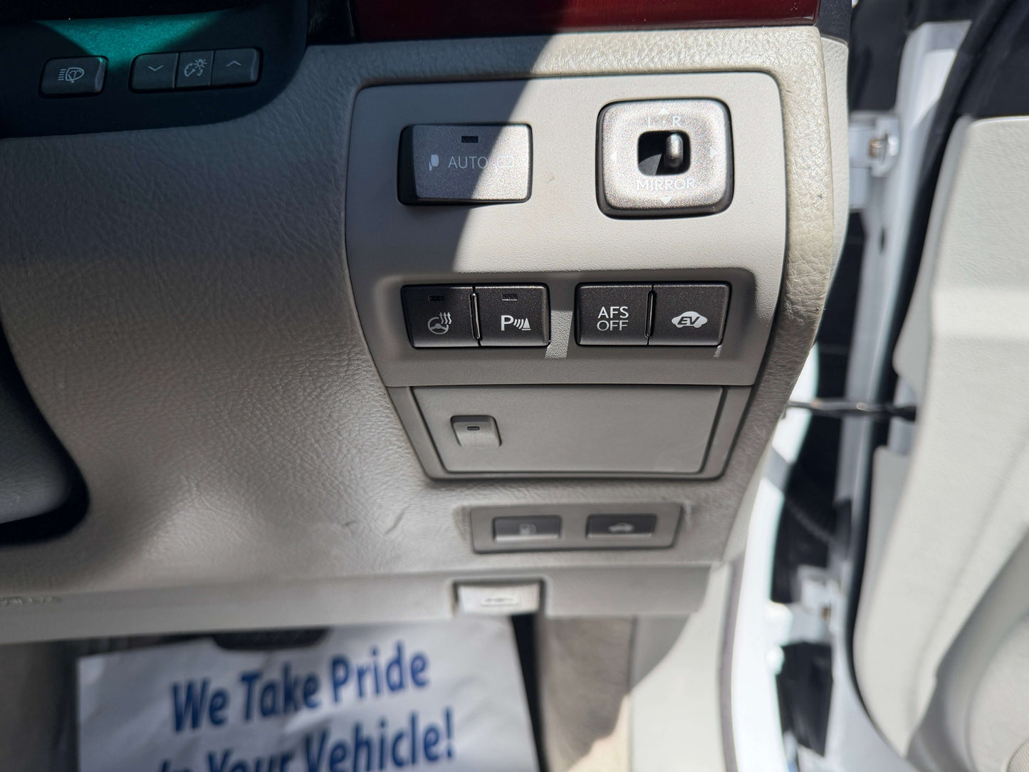 Interior controls of a 2007 Lexus LS600hL AWD V8 5.0L Hybrid Luxury Sedan, featuring various buttons including AFS off and parking brake.