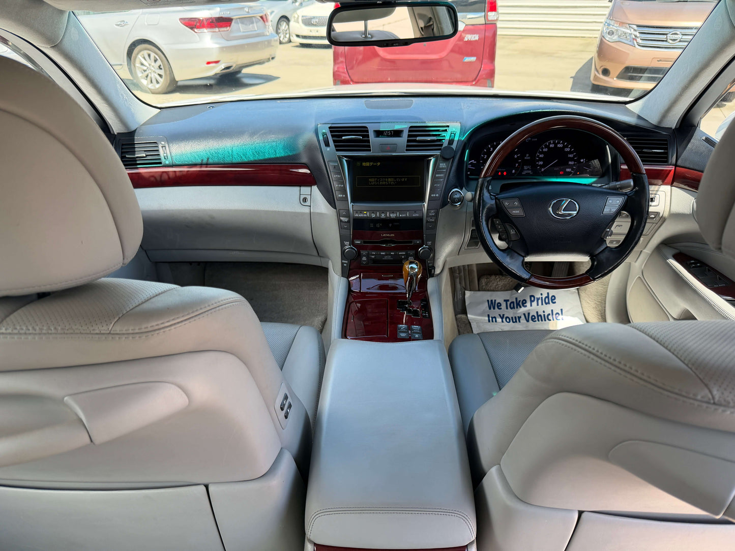 Interior view of a 2007 Lexus LS600hL AWD V8 5.0L Hybrid Luxury Sedan showing dashboard and leather seats.