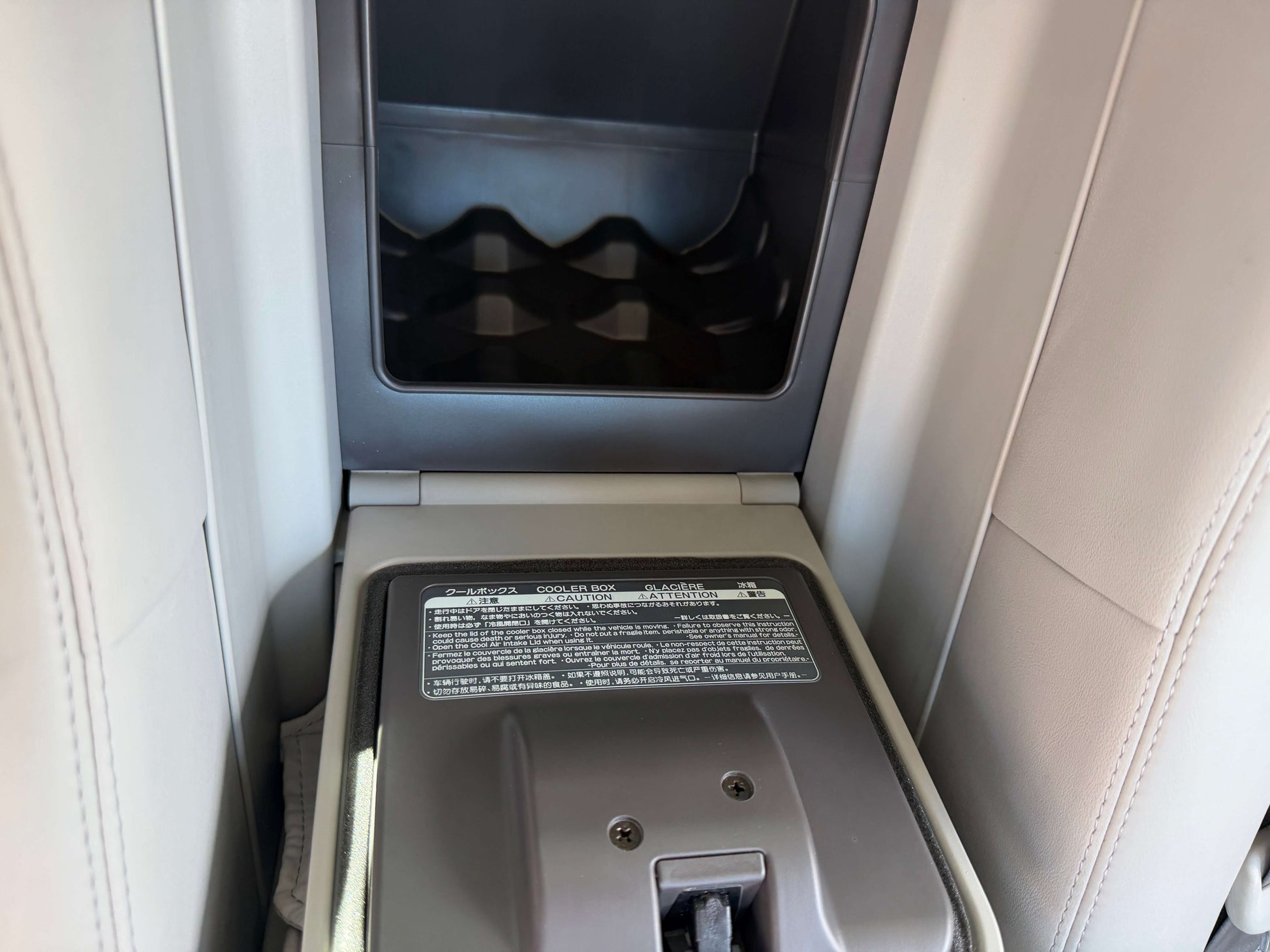 Interior center console of a 2007 Lexus LS600hL AWD V8 5.0L Hybrid Luxury Sedan with storage compartment.