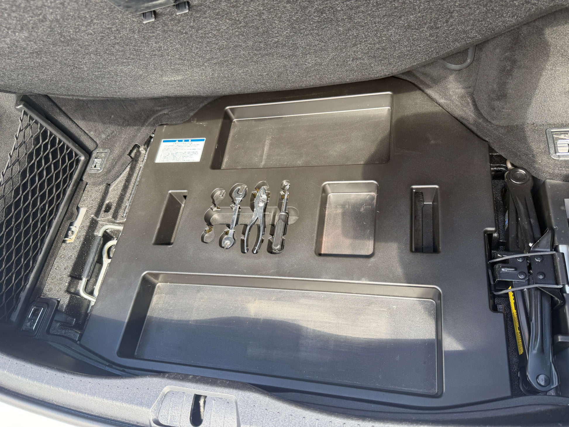 Tool storage compartment in the trunk of a 2007 Lexus LS600hL AWD V8 5.0L Hybrid Luxury Sedan.
