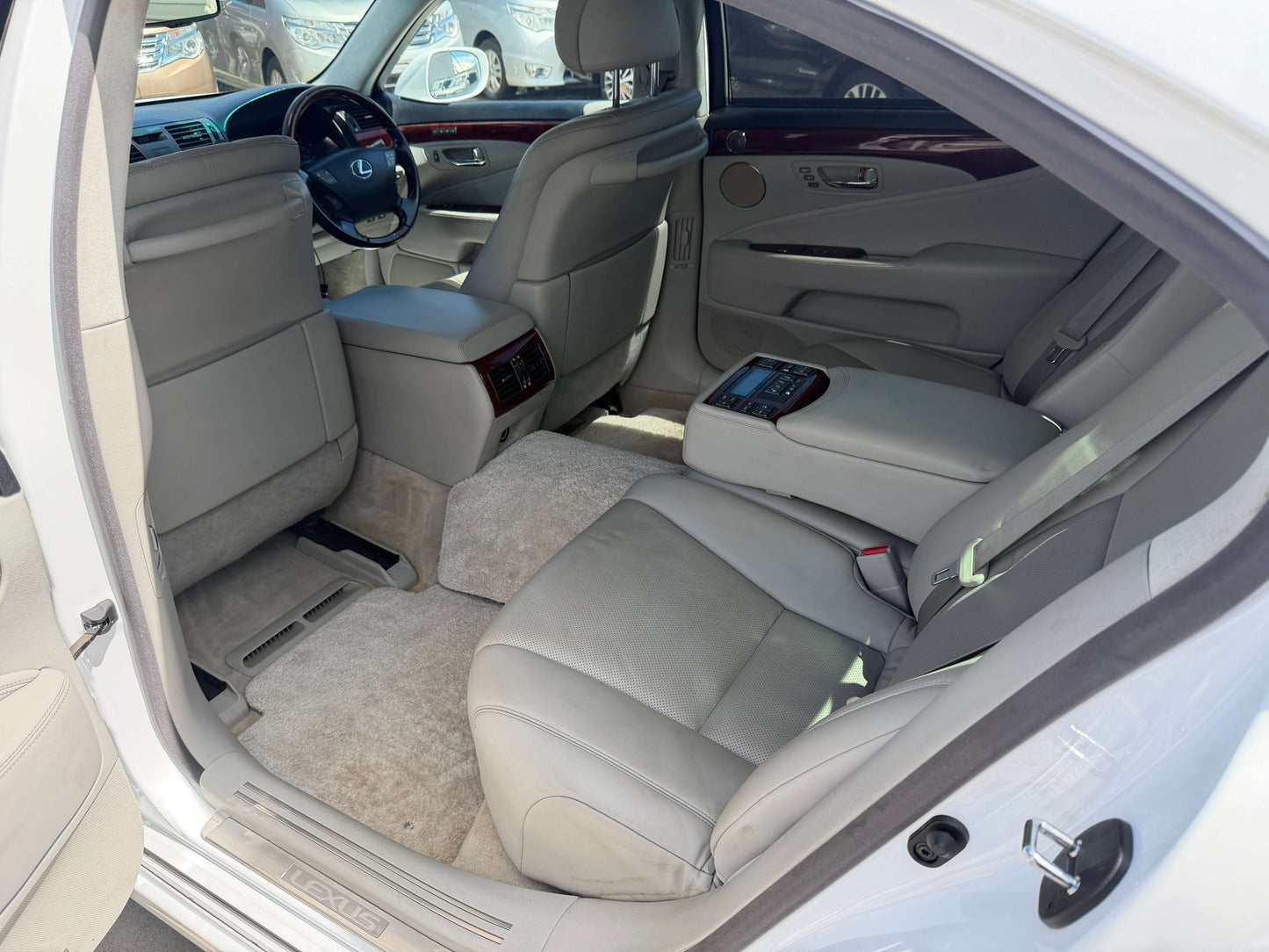 Interior view of 2007 Lexus LS600hL AWD V8 5.0L Hybrid Luxury Sedan showcasing spacious leather seating.