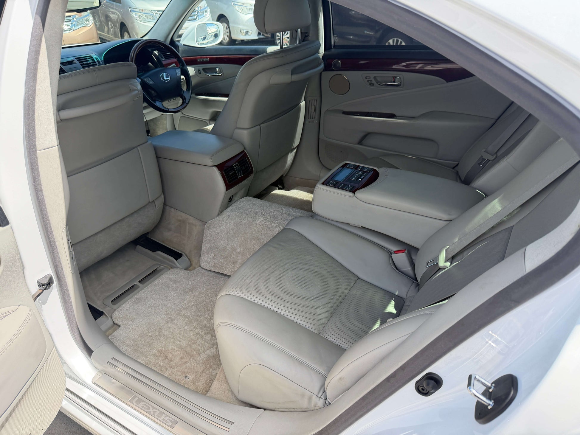 Interior view of 2007 Lexus LS600hL AWD V8 5.0L Hybrid Luxury Sedan showcasing spacious leather seating.