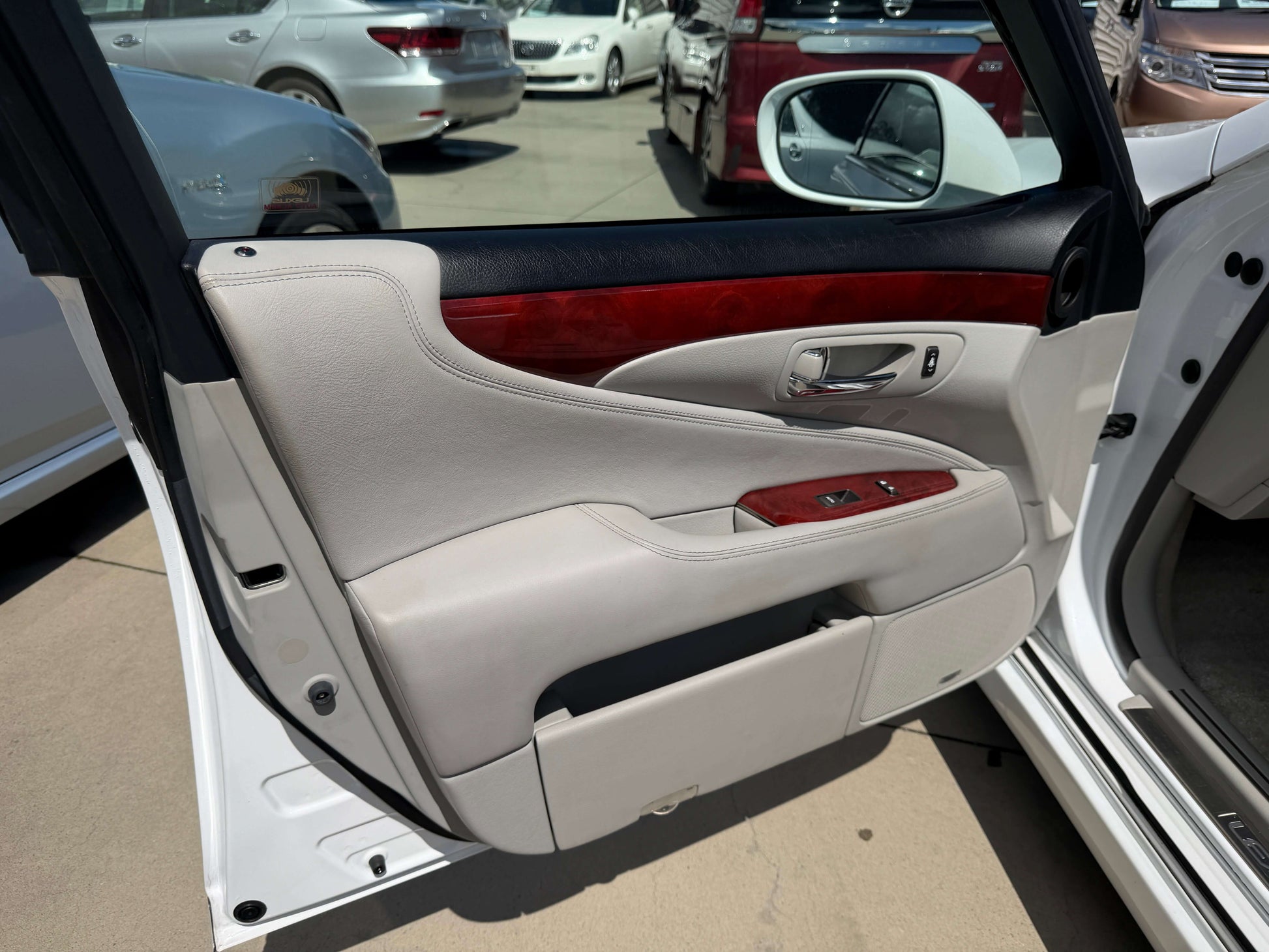Interior view of the 2007 Lexus LS600hL AWD V8 5.0L Hybrid luxury sedan door panel with wood accents.