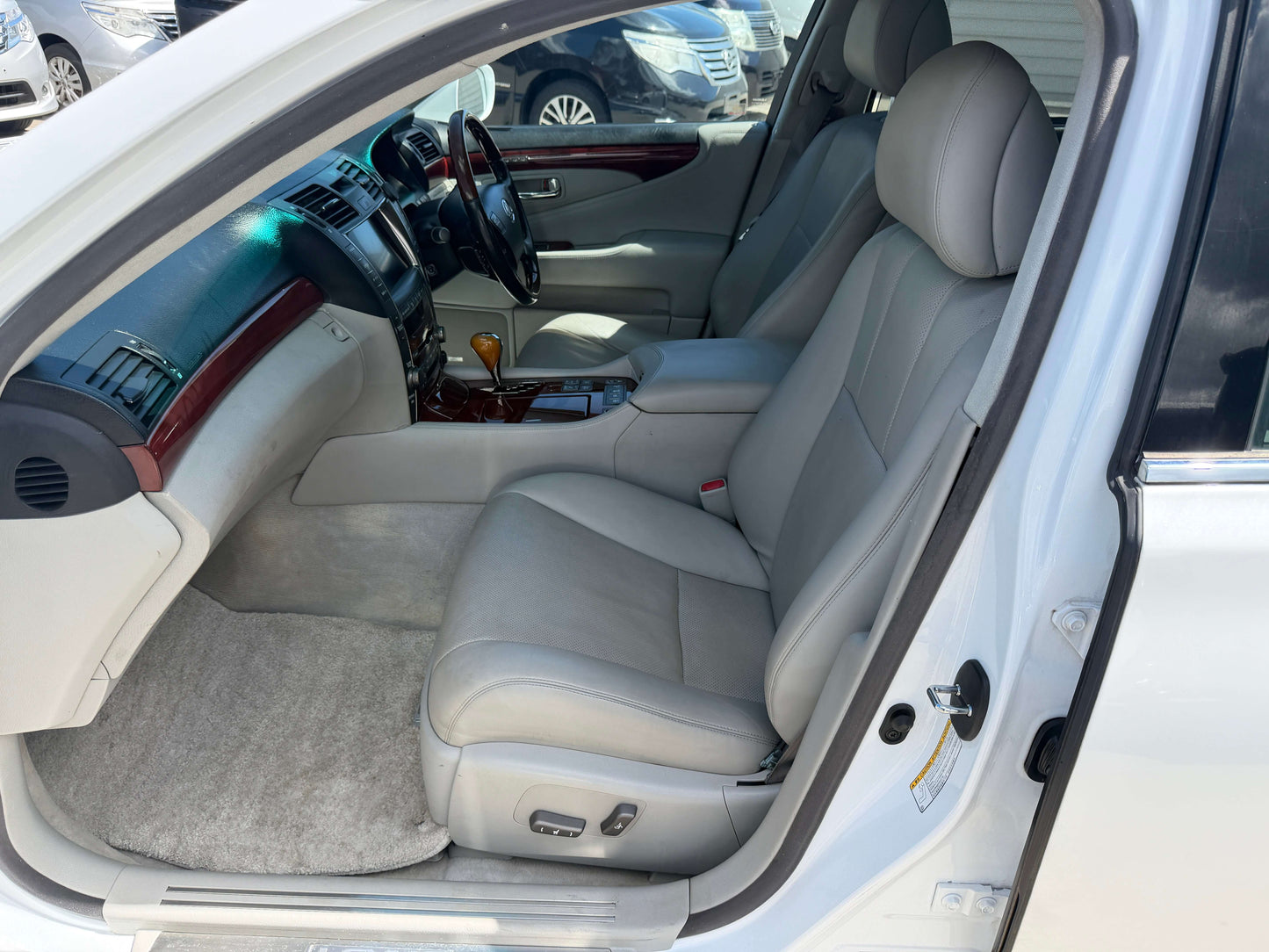 Interior view of the 2007 Lexus LS600hL AWD V8 5.0L Hybrid Luxury Sedan showcasing leather seating and premium finishes.