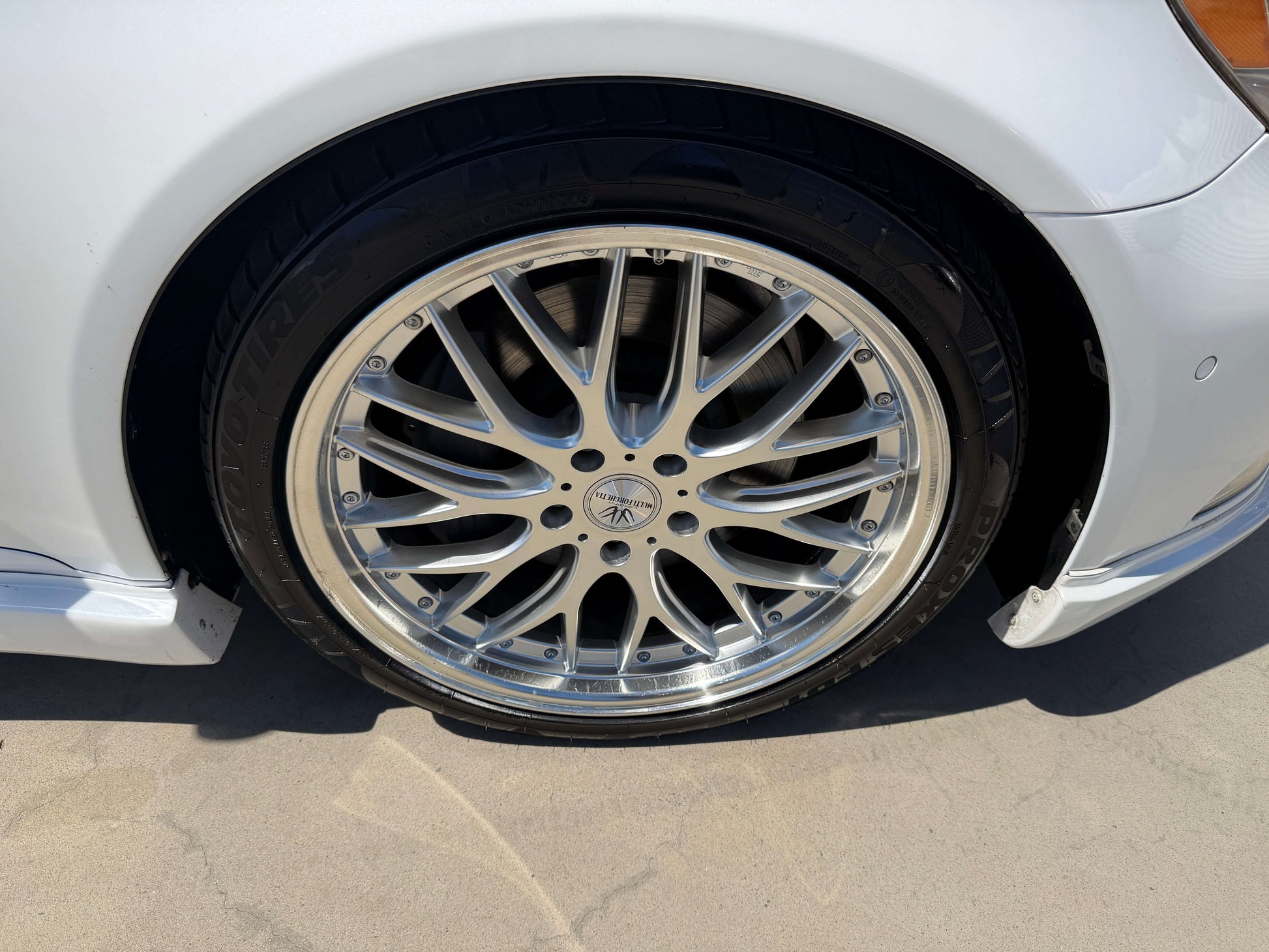 2007 Lexus LS600hL AWD V8 5.0L Hybrid luxury sedan wheel close-up showcasing intricate design and shiny chrome finish.
