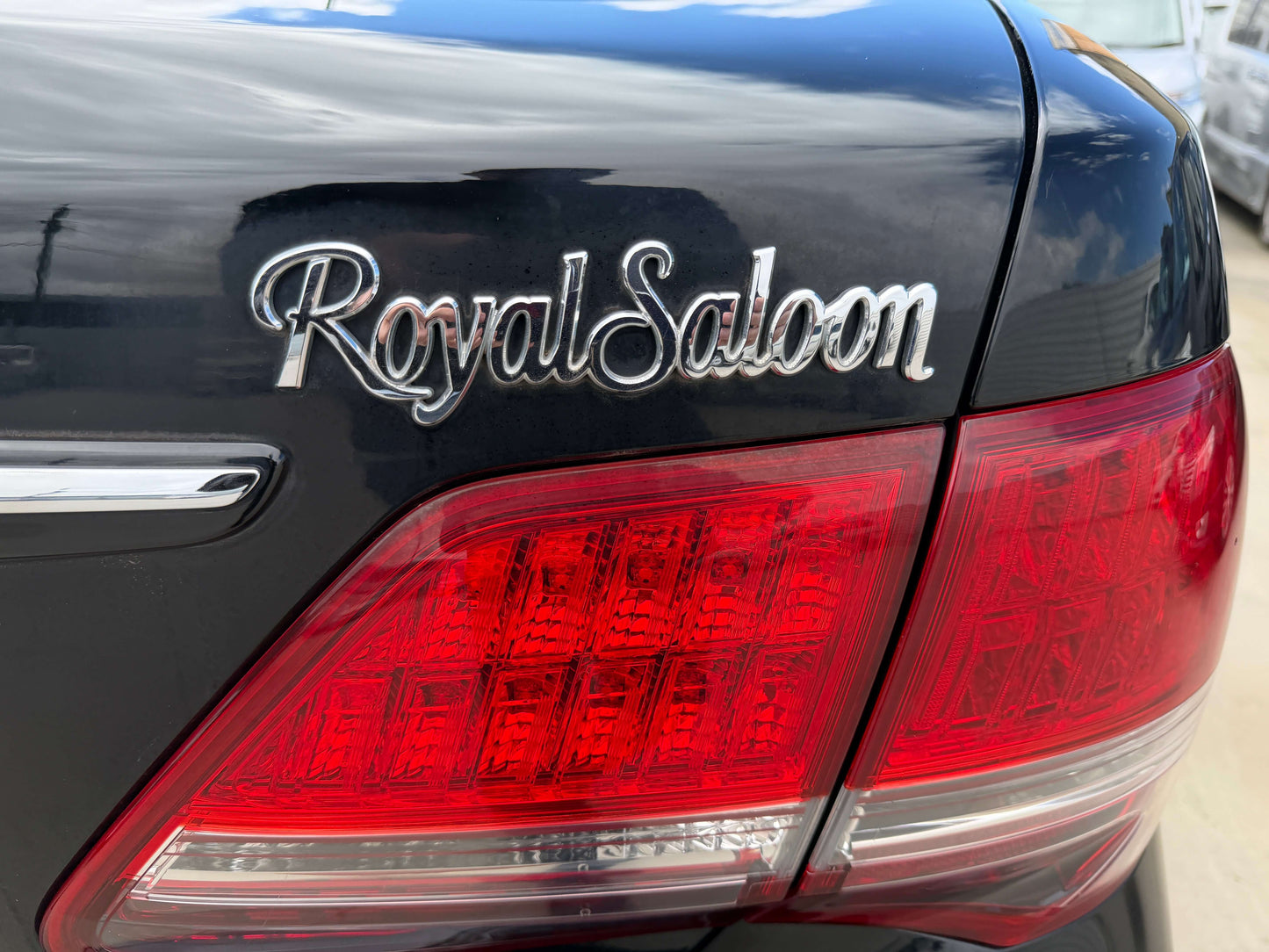 Close-up of the Royal Saloon badge on the 2008 Toyota Crown V6 3.0L, showcasing luxury sedan detailing.