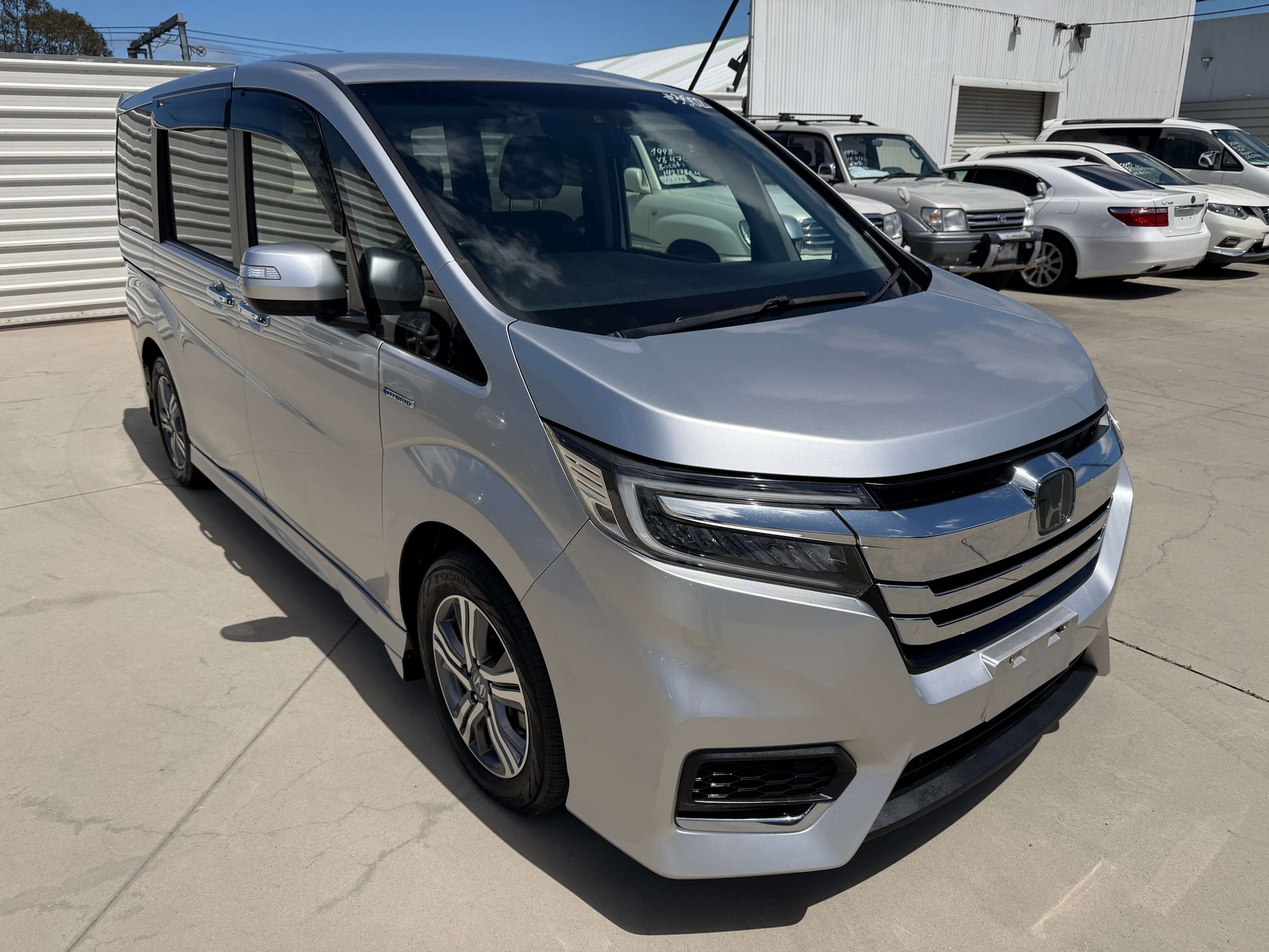 2019 Honda Honda Stepwgn 2.0 Spada Hybrid G Honda Sensing parked in a lot, showcasing its sleek silver exterior.