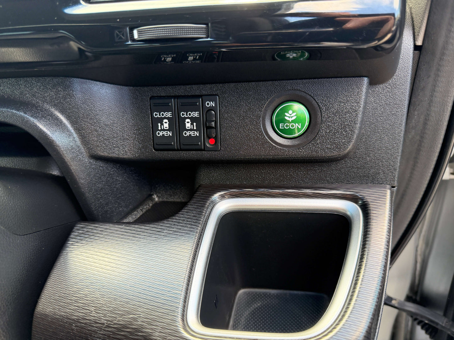 Interior controls of the 2019 Honda Honda Stepwgn 2.0 Spada Hybrid including ECON button and window switches.