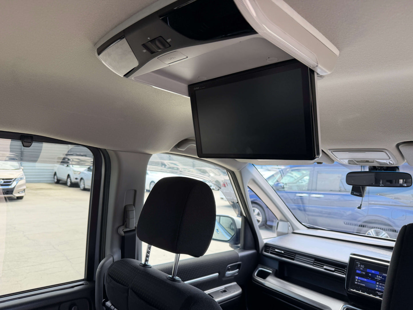 Interior view of a 2019 Honda Honda Stepwgn 2.0 Spada Hybrid showing overhead monitor and dashboard features.