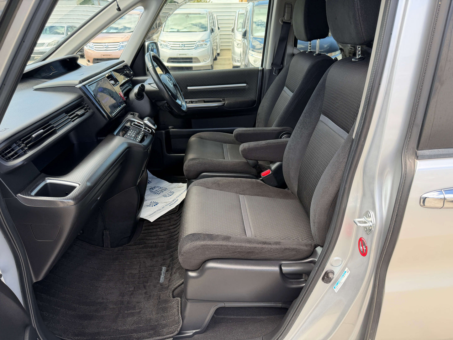 Interior view of 2019 Honda Honda Stepwgn 2.0 Spada Hybrid with spacious seating and modern dashboard design.