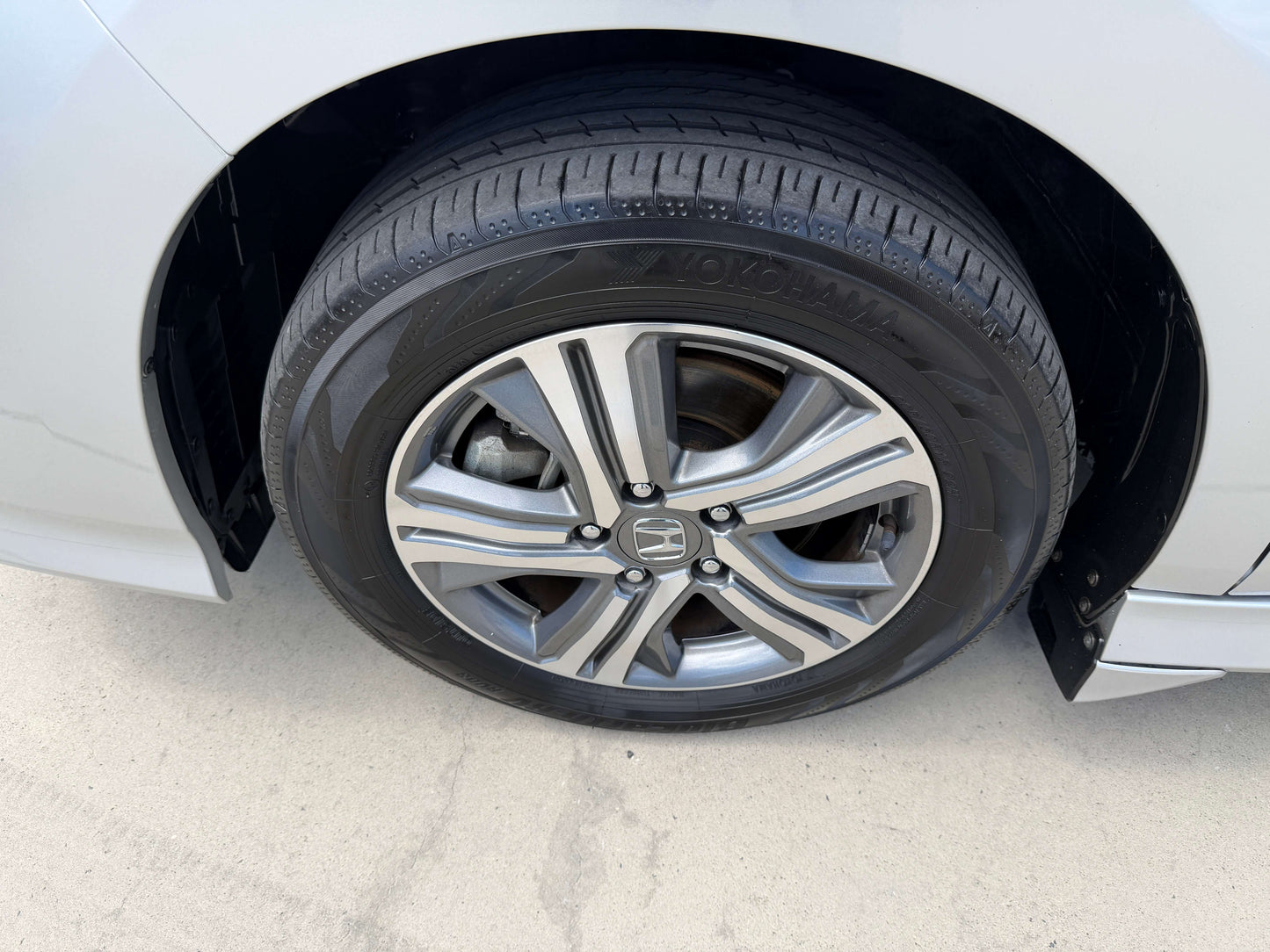2019 Honda Honda Stepwgn 2.0 Spada Hybrid wheel and tire close-up, showcasing alloy wheel design and tread pattern.