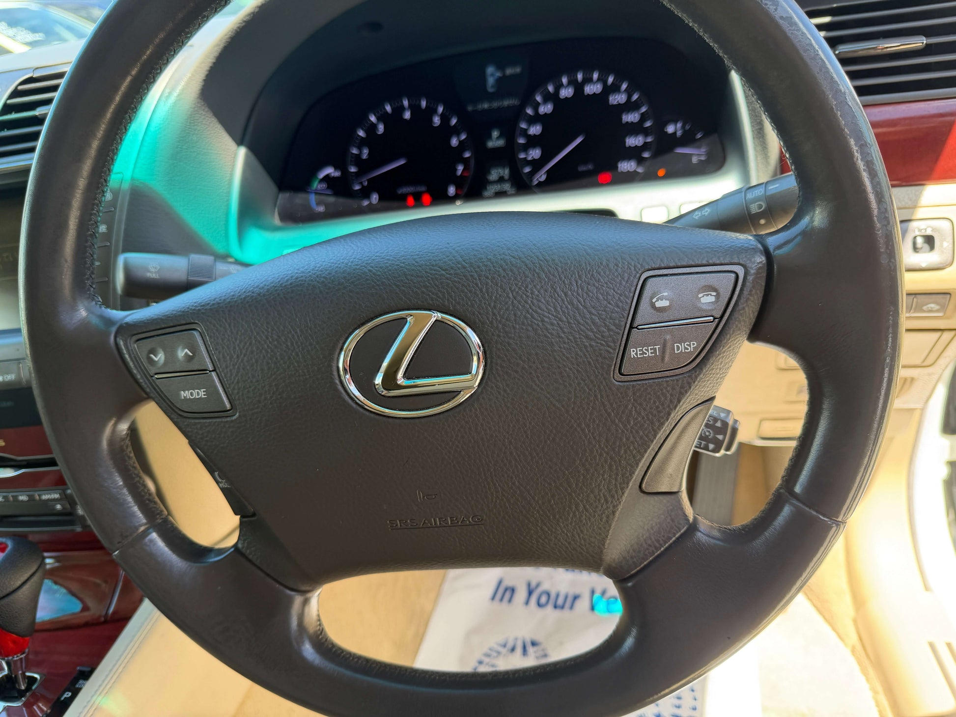 Interior view of the 2007 Lexus LS600h AWD V8 5.0L Hybrid steering wheel with control buttons.