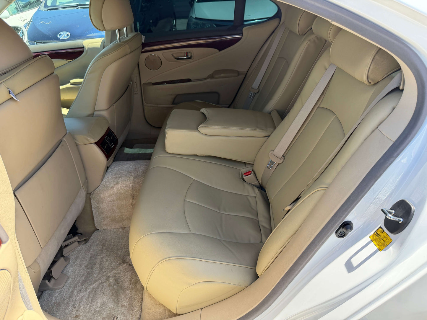 Interior view of the rear seats in a 2007 Lexus LS600h AWD V8 5.0L Hybrid luxury sedan, featuring beige leather upholstery.