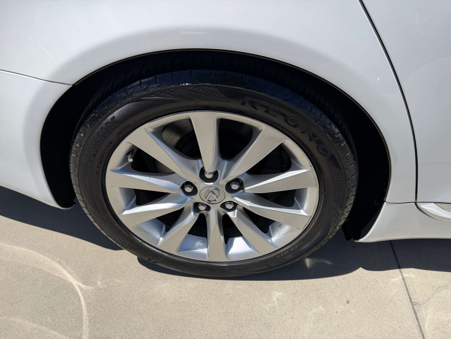 Close-up of wheel and alloy rim of 2007 Lexus LS600h AWD V8 5.0L Hybrid Luxury Sedan.