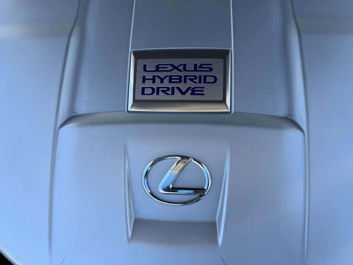 Lexus Hybrid Drive emblem on the engine cover of a 2007 Lexus LS600h AWD V8 5.0L Hybrid luxury sedan