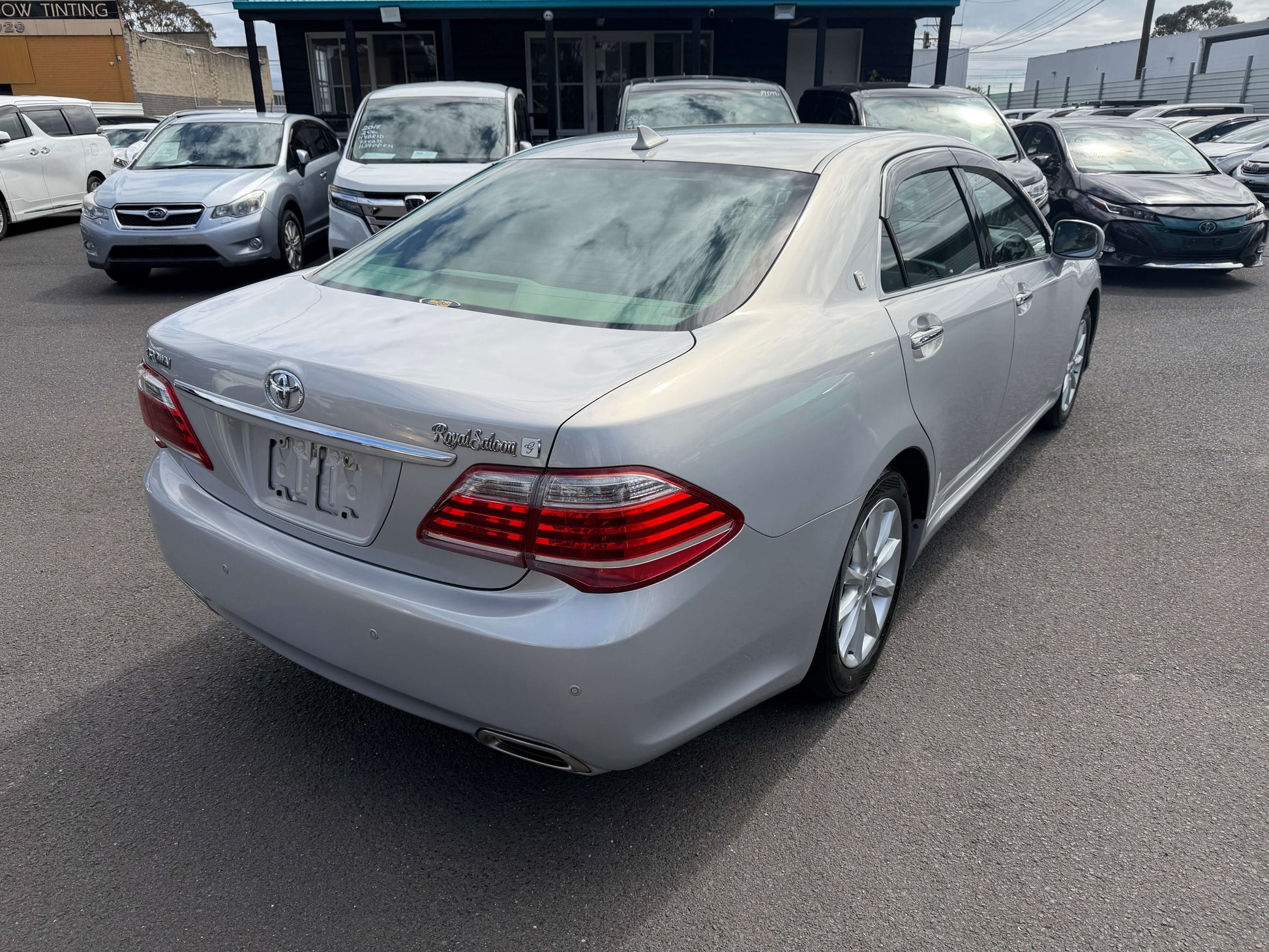 2010 Toyota Crown V6 3.0L Royal Saloon G Edition Luxury Sedan rear view with sleek silver finish and stylish taillights.