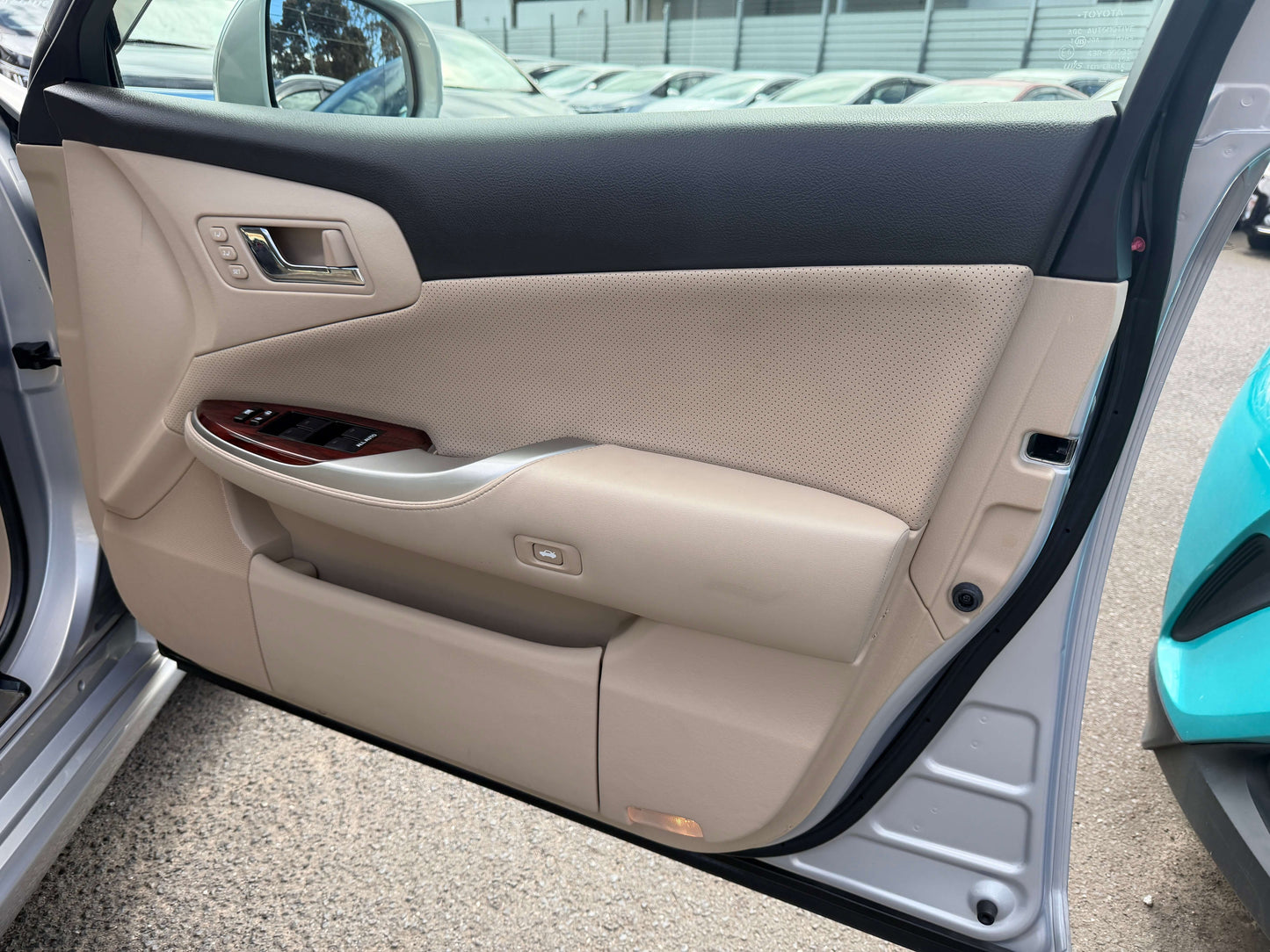 Interior view of the 2010 Toyota Crown V6 3.0L Royal Saloon G Edition luxury sedan door panel.