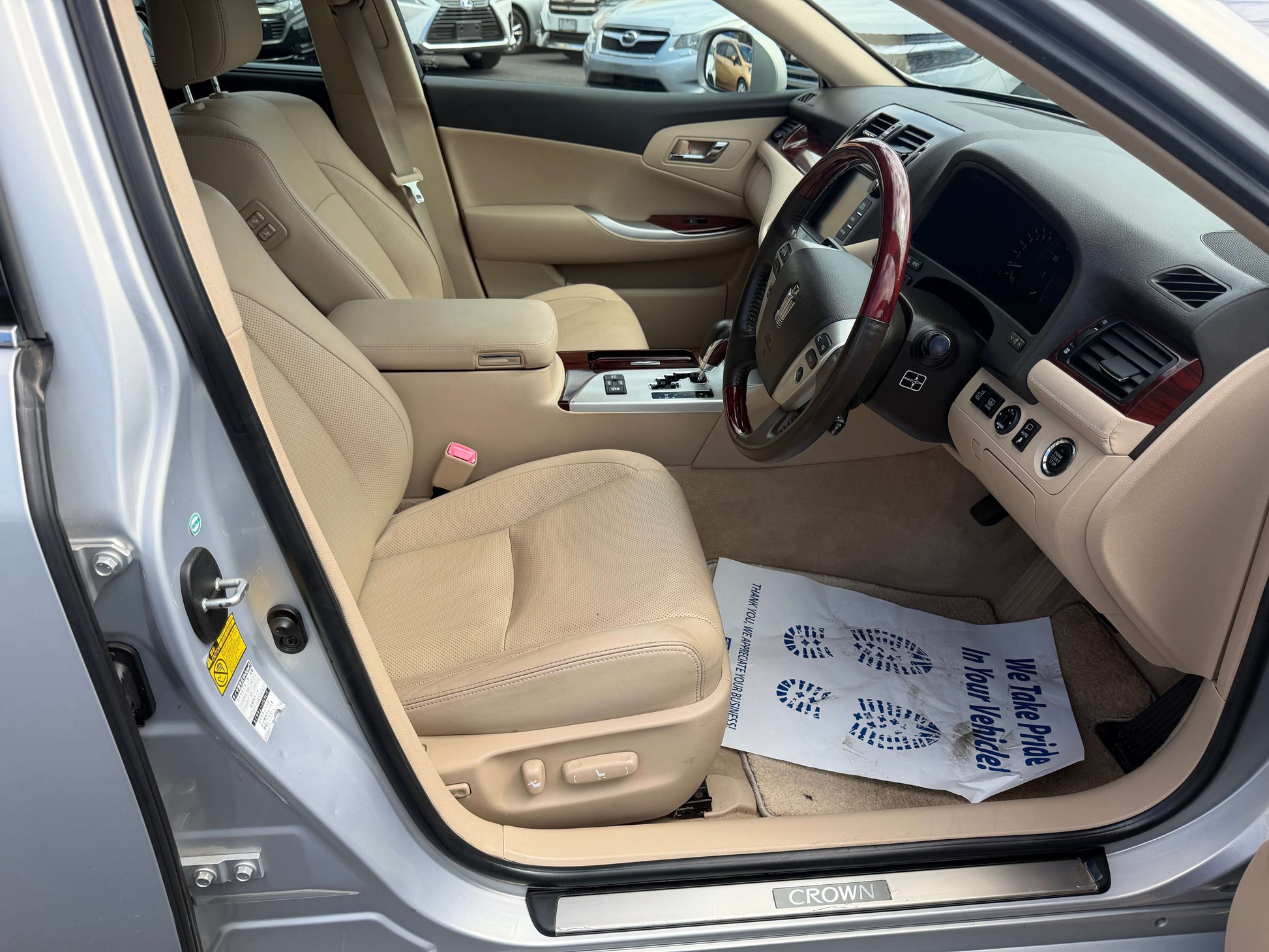 Interior view of 2010 Toyota Crown V6 3.0L Royal Saloon G Edition Luxury Sedan showcasing beige leather seats.