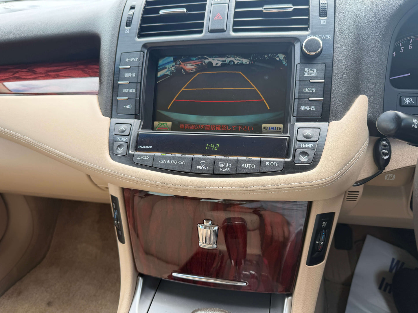 Interior dashboard of a 2010 Toyota Crown V6 3.0L featuring a reversing camera display and luxury finishes.